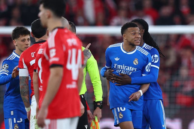 <p>Kylian Mbappe is held back as he clashes with Benfica players after the match was halted</p>