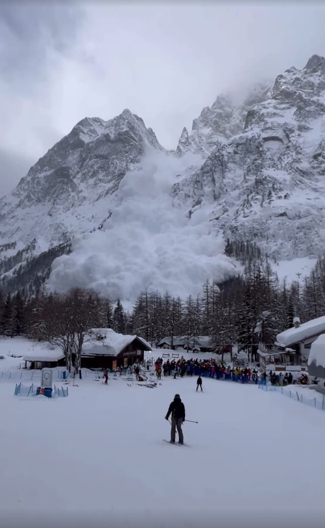 <p>People begin to flee as the avalanche looms over the pine trees</p>
