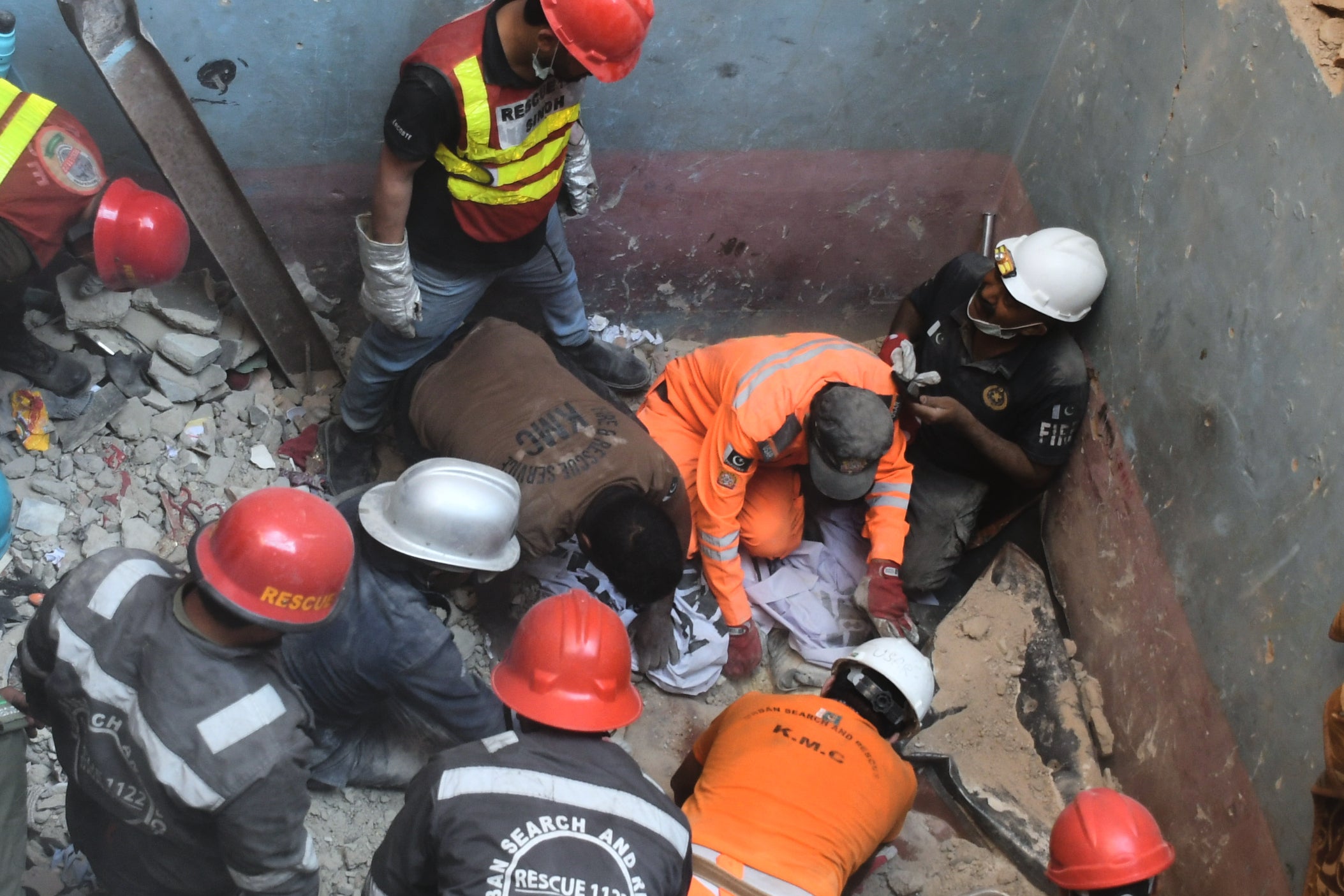 Rescue workers recover a body from the rubble following a gas explosion in an apartment building in Karachi, Pakistan, Thursday, 19 February 2026