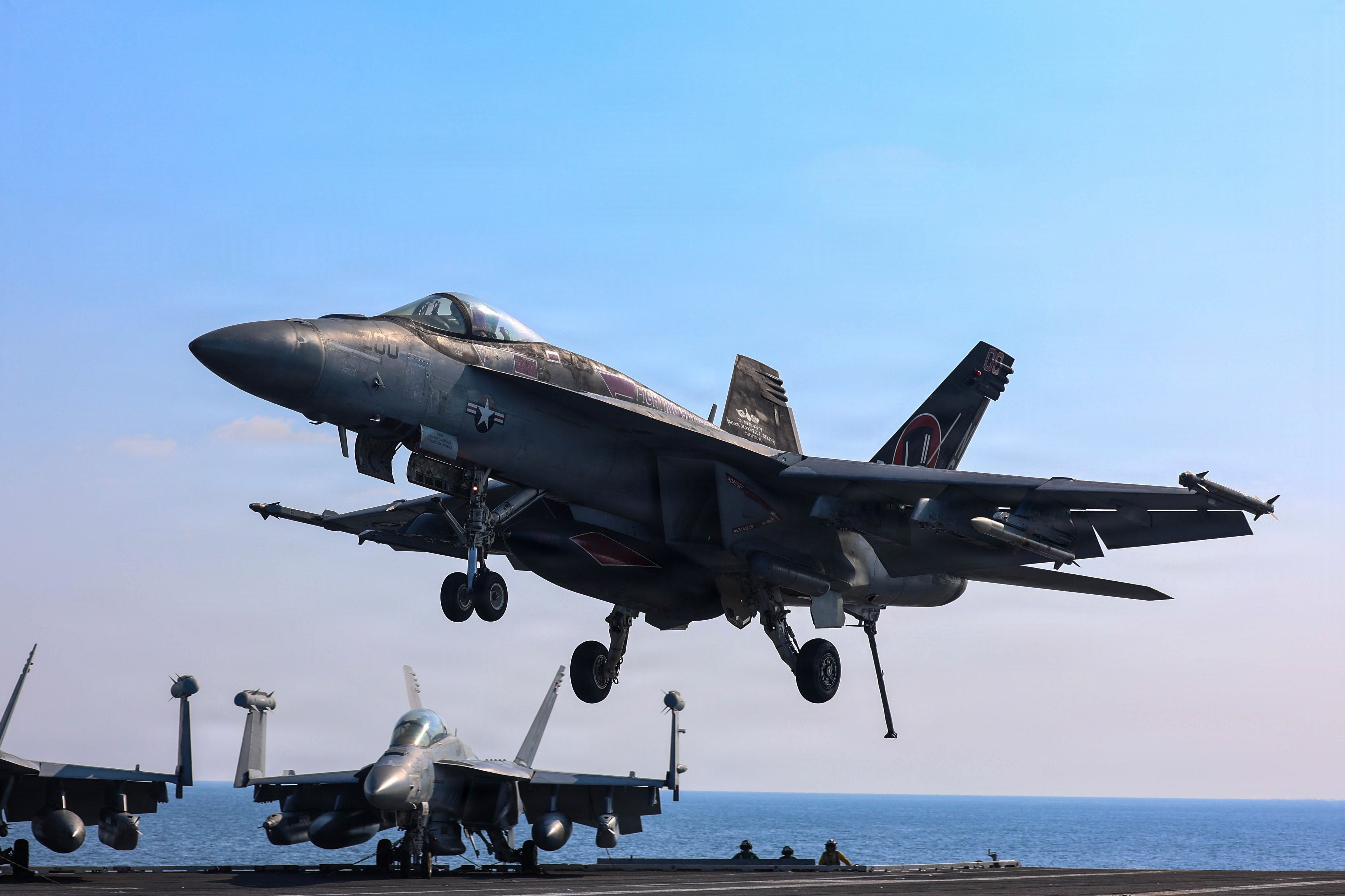 F/A-18 Super Hornets from Strike Fighter Squadron 14 land on the deck of USS Abraham Lincoln (CVN 72) in the Arabian Sea