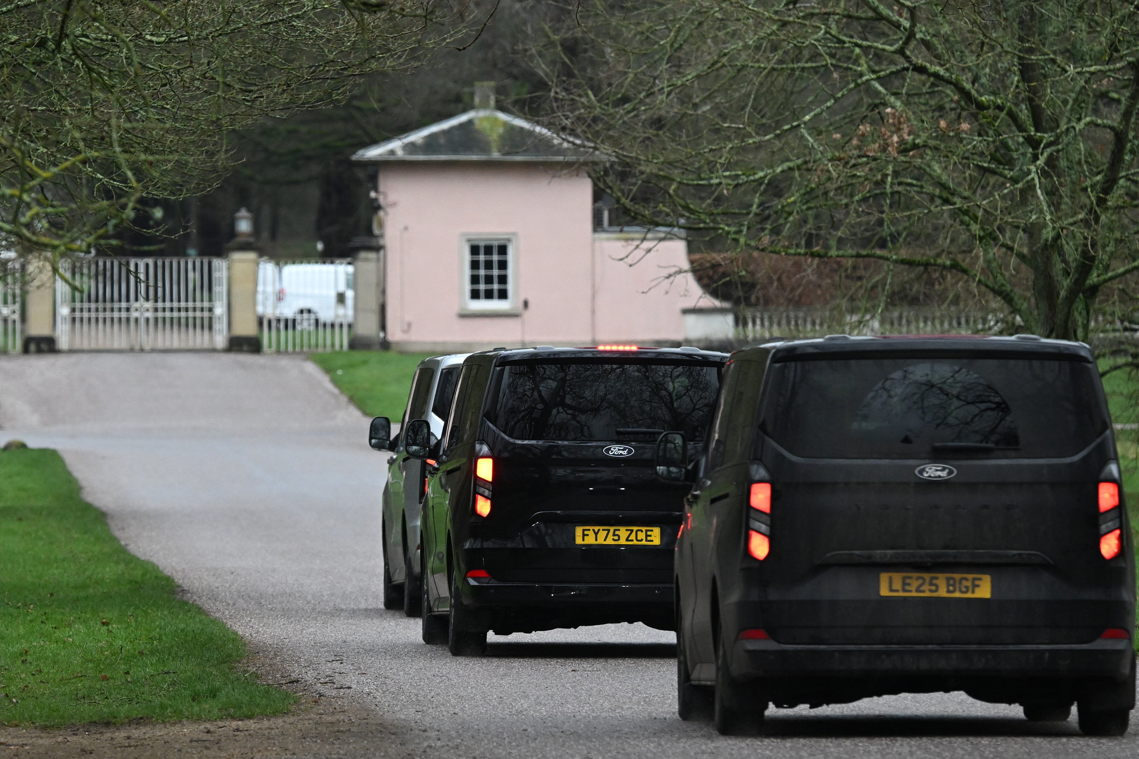 Unmarked Police vehicles enter the gates of the Royal Lodge, Andrew Mountbatten-Windsor's former residence