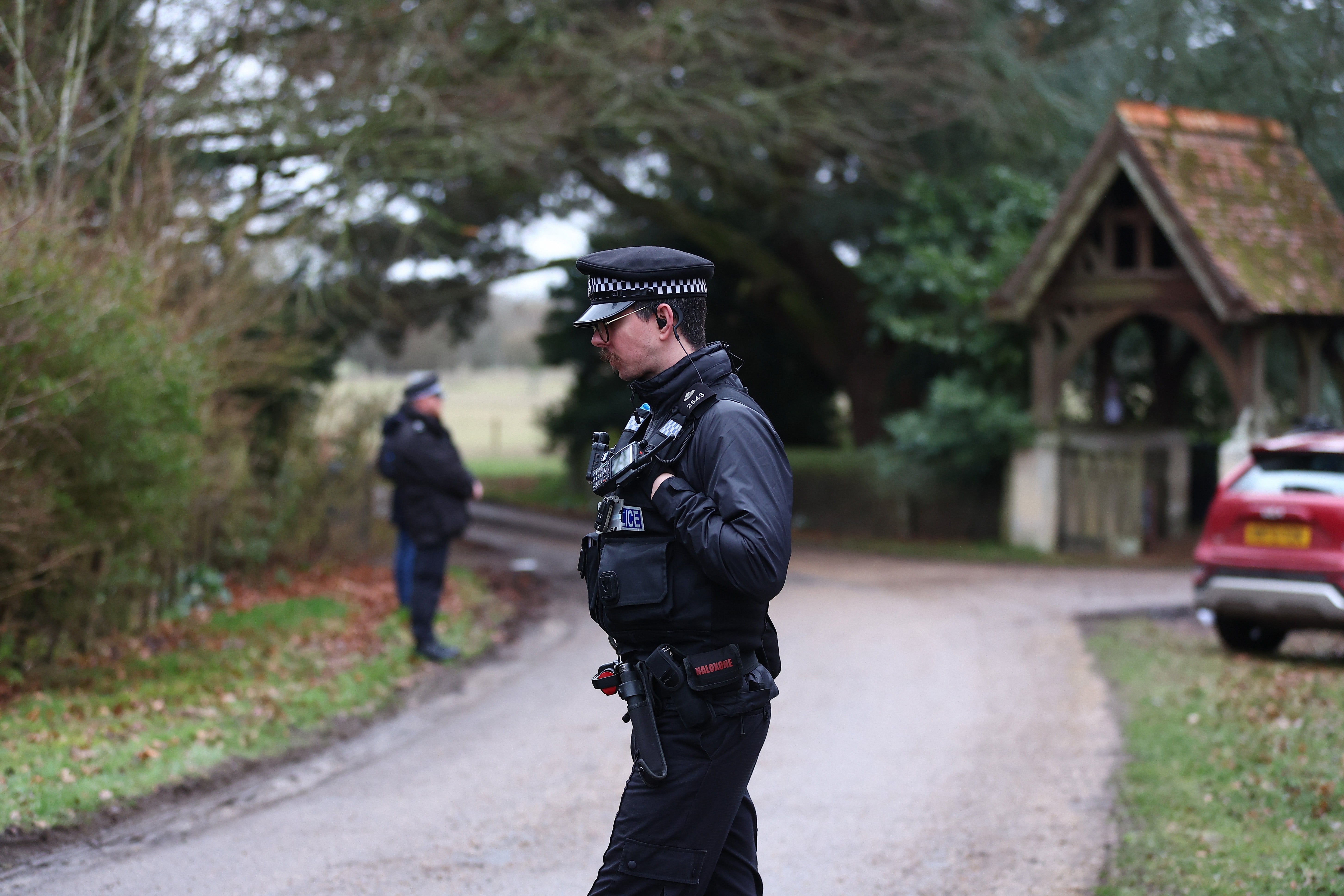 Police officers standing guard at the entrance to Mountbatten-Windsor’s home, Wood Farm, in Sandringham