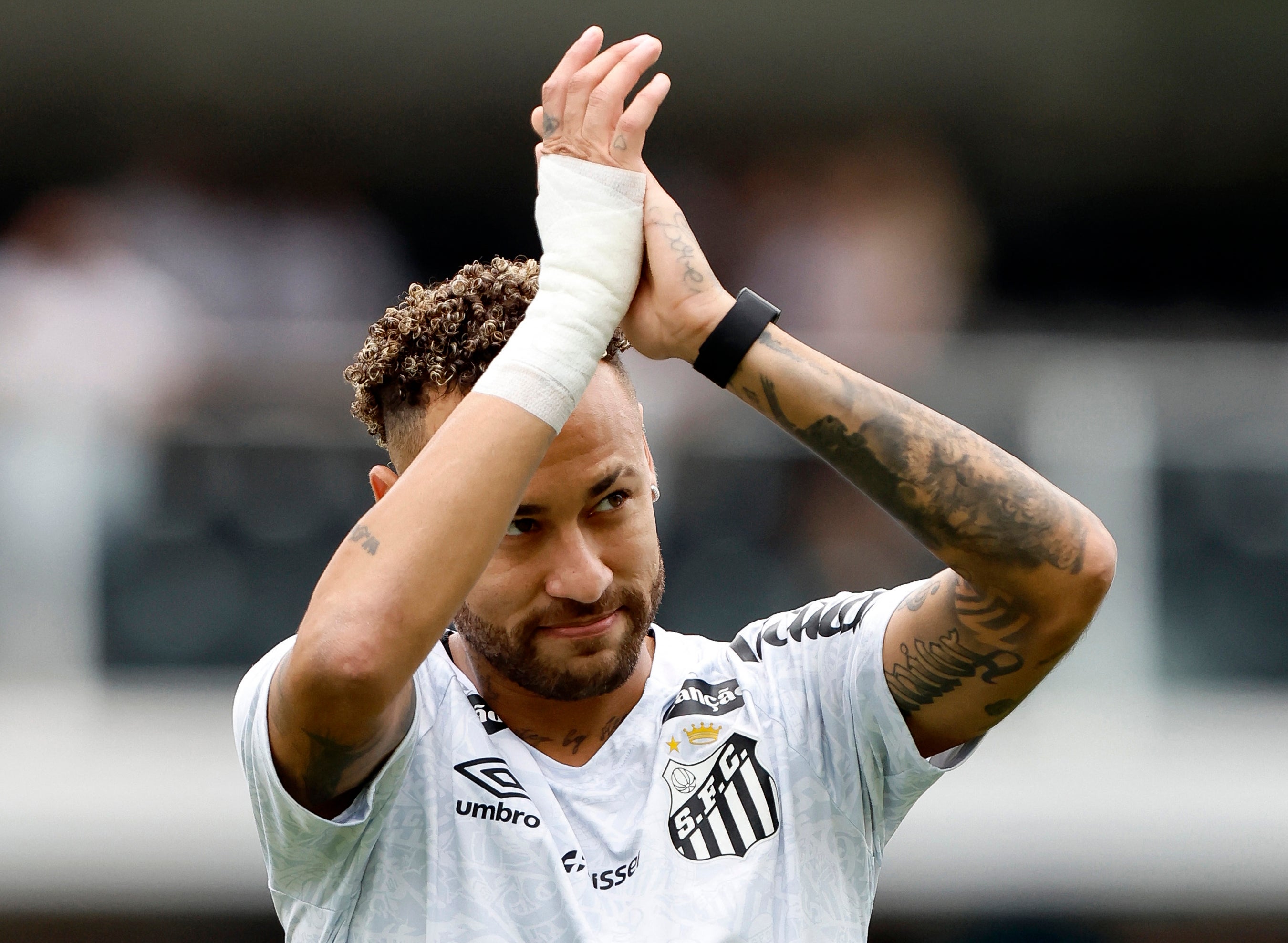 <p>Santos' froward #10 Neymar greets fans during a tribute for scoring 150 goals for the club</p>