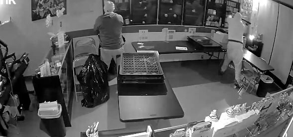 The video appears to show one of the suspects using a sledgehammer to break into glass cases mounted on the walls of DOWE Collectibles that were filled with Pokémon cards