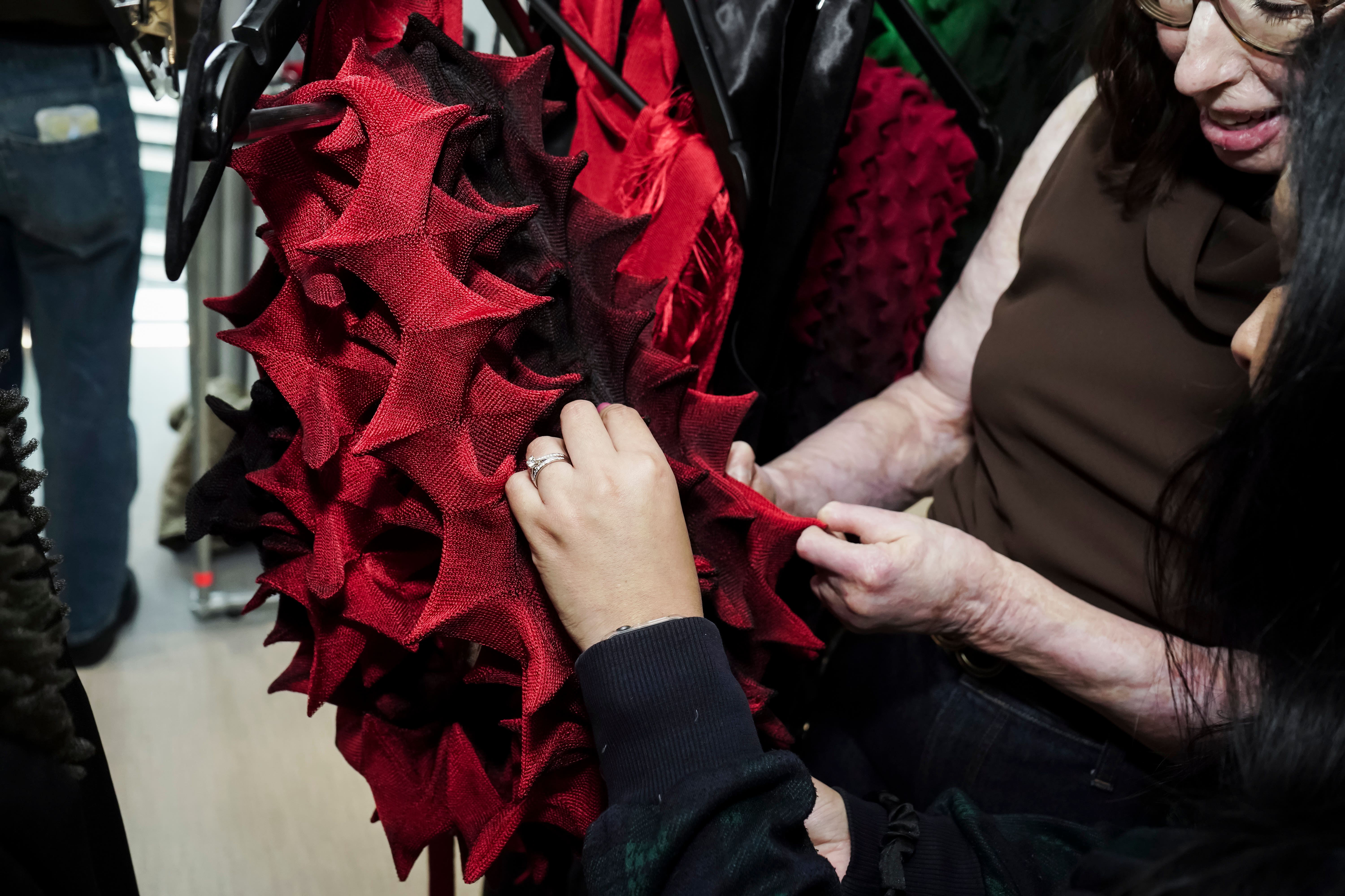 Blind and low-vision guests touching Chet Lo garments for his autumn/winter 2026 collection (Madoka Takei/PA)