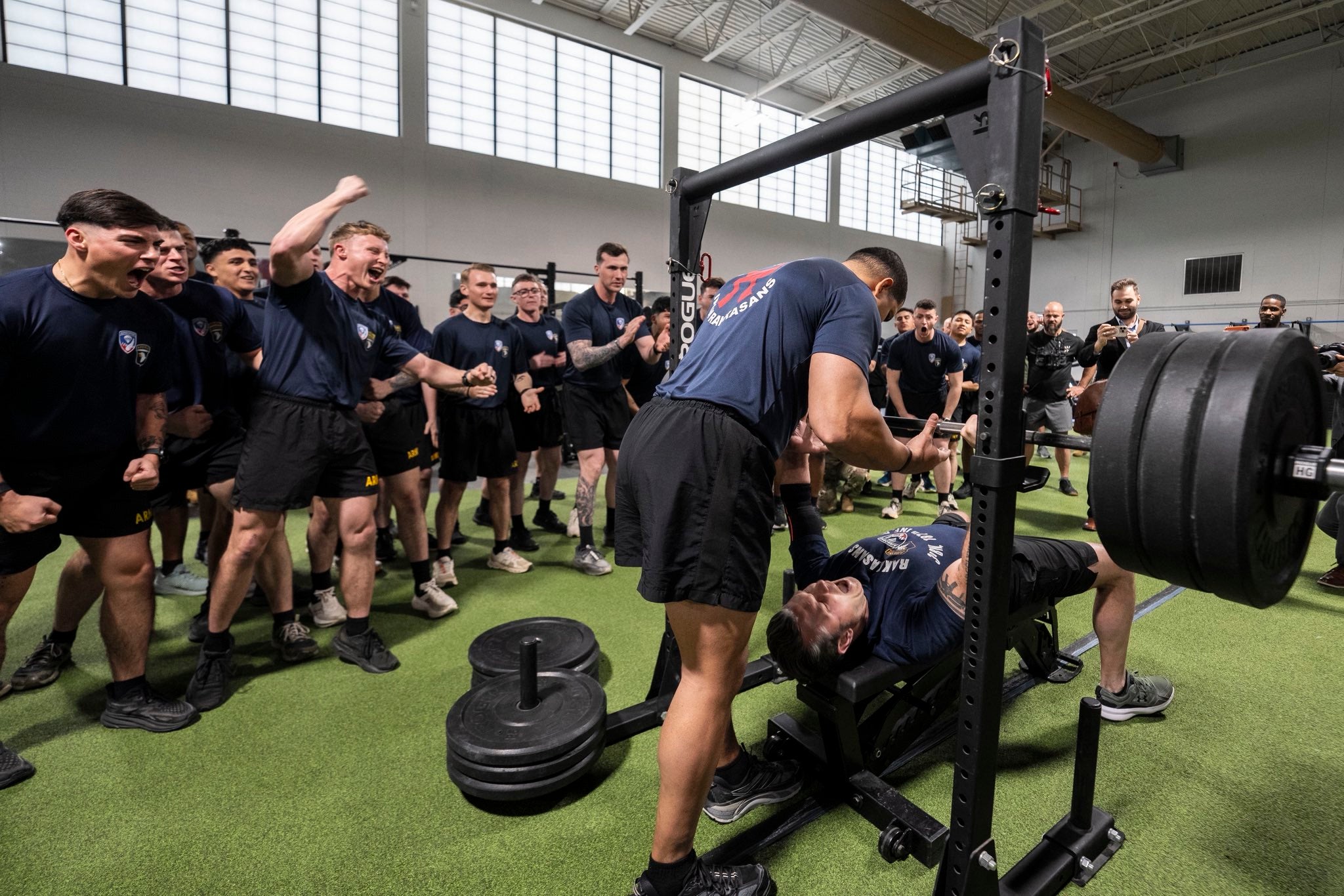 In another video shared Friday, Hegseth, a military veteran, was cheered on by troops at his former base Fort Campbell as he bench-pressed in front of them