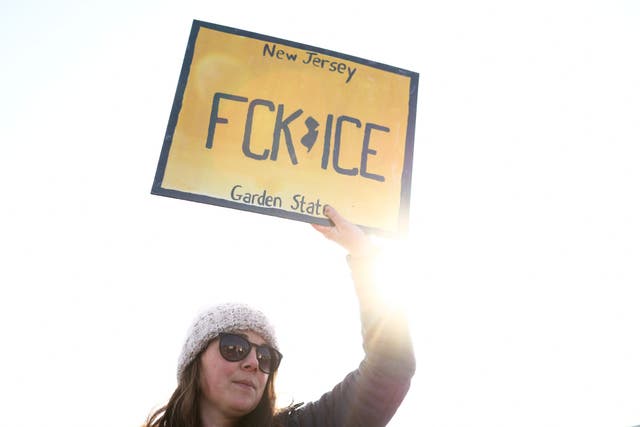 <p>A person holds a sign during a February 2026 protest in Roxbury, New Jersey, as local legislators introduce new legislation</p>