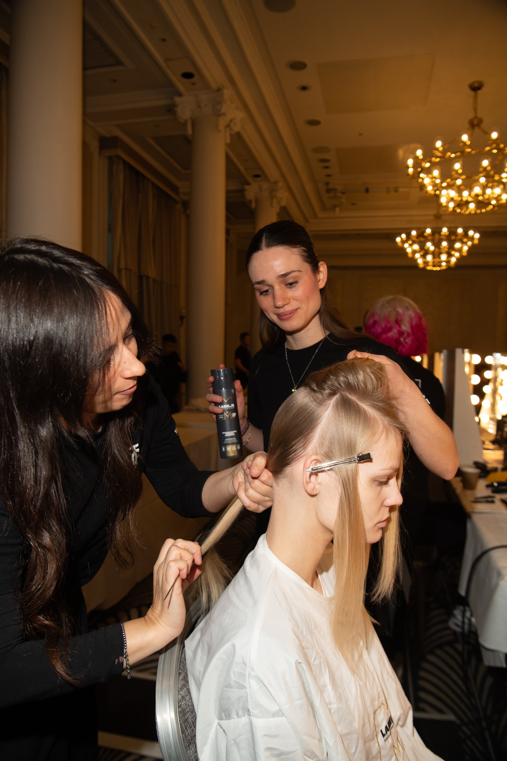 Smooth, straight hair backstage on blonde model at the Paul Costelloe show