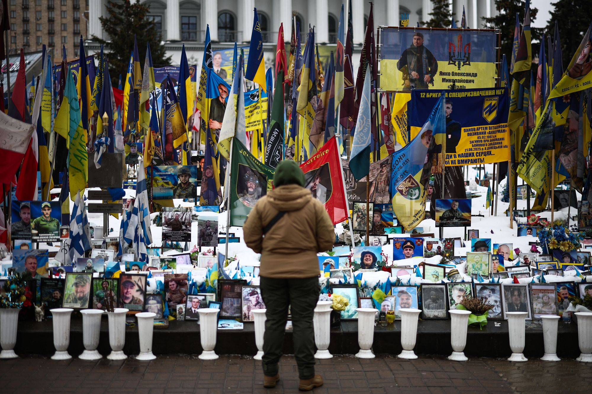A person stands at a makeshift memorial to fallen Ukrainian and foreign soldiers in Independence Square in Kyiv
