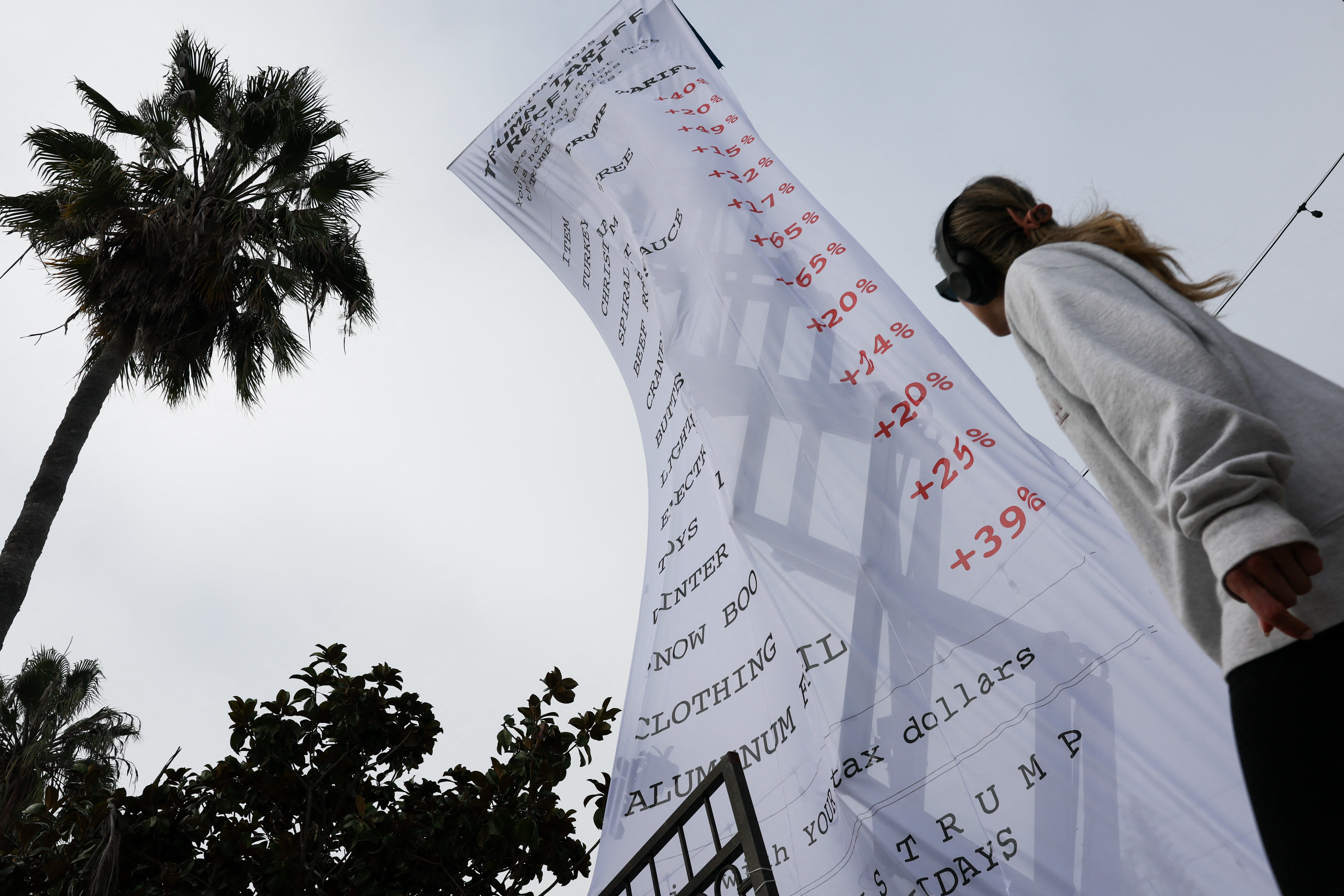 A 40-foot-long banner, depicting a purchase receipt, is displayed by the progressive organization MoveOn to protest against Trump's tariffs in Los Angeles on December 12, 2025