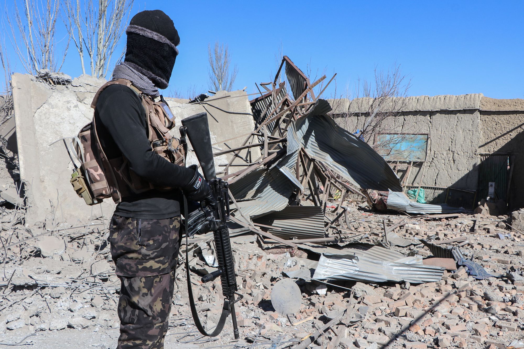 <p>A Taliban security personnel stands next to the debris of houses destroyed during an overnight Pakistani airstrike at the Balish village in Urgun district, Paktika Province, on 22 February 2026</p>