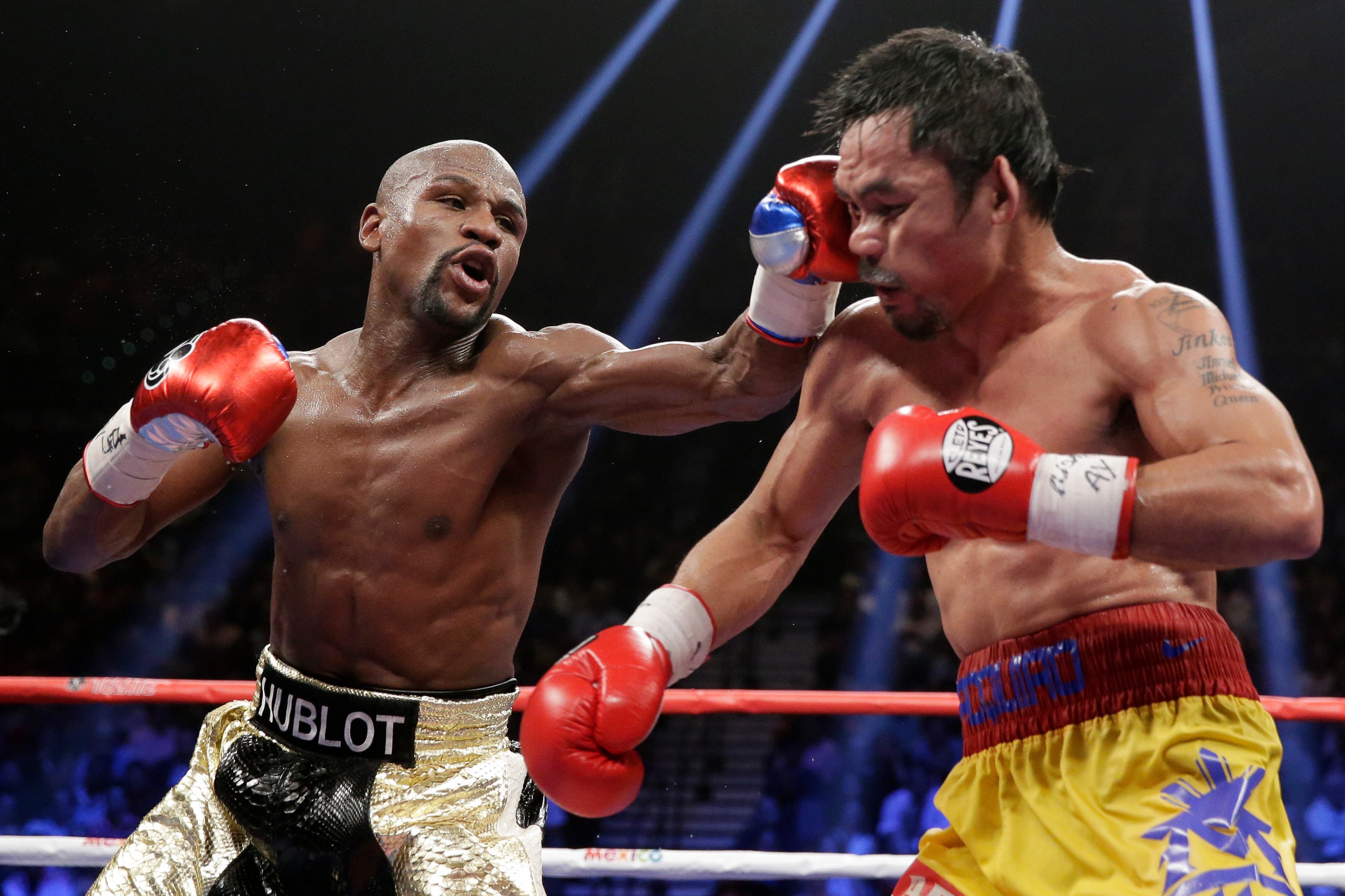 Mayweather, Jr. of the U.S. lands a left to the face of Pacquiao of the Philippines in the 11th round during their welterweight title fight in Las Vegas