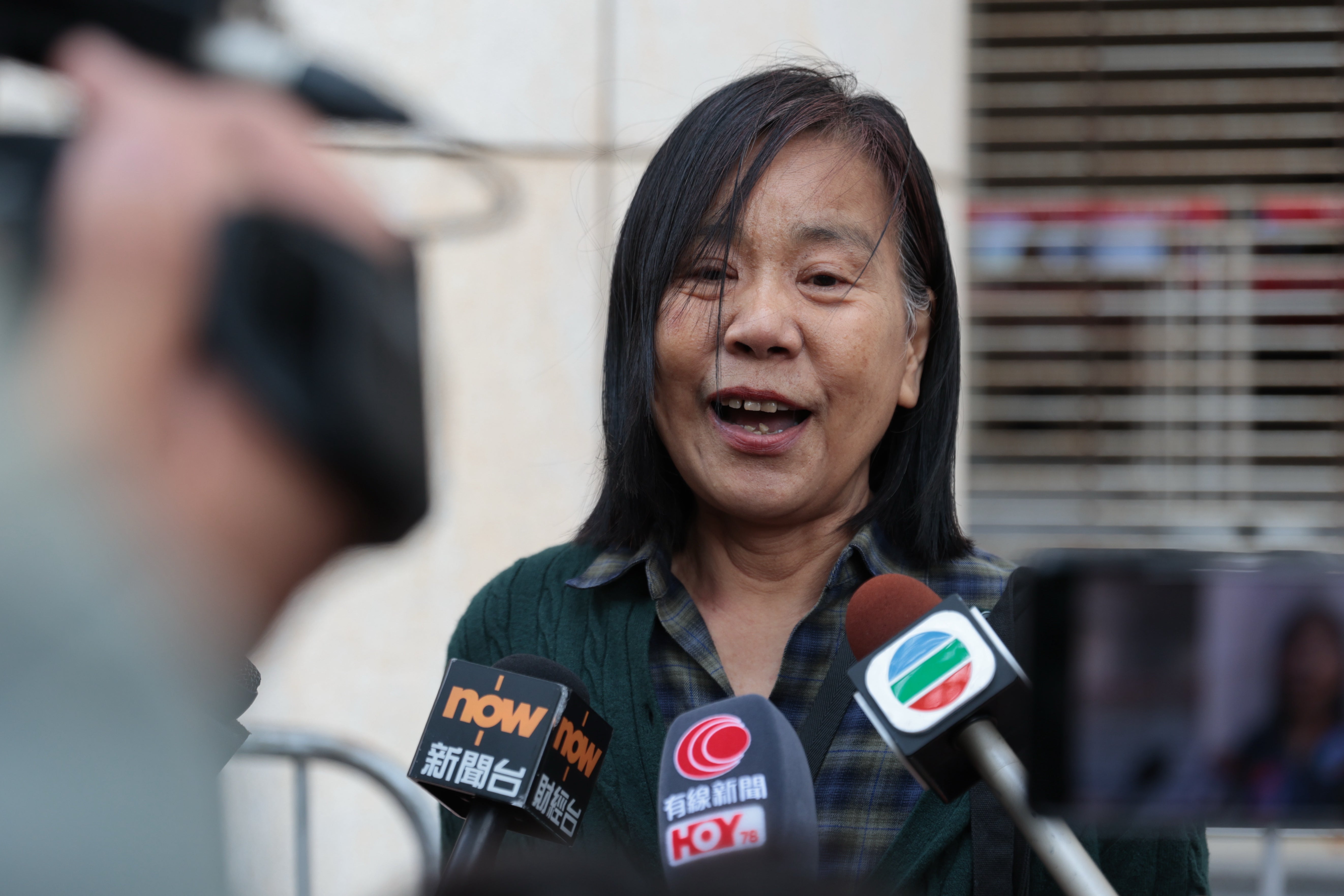 Chan Po-ying, wife of Leung Kwok-hung, one of the defendants in the national security case and the former chairperson of the now-disbanded League of Social Democrats speaks to journalists outside the West Kowloon Law Courts Building after the national security appeal cases,