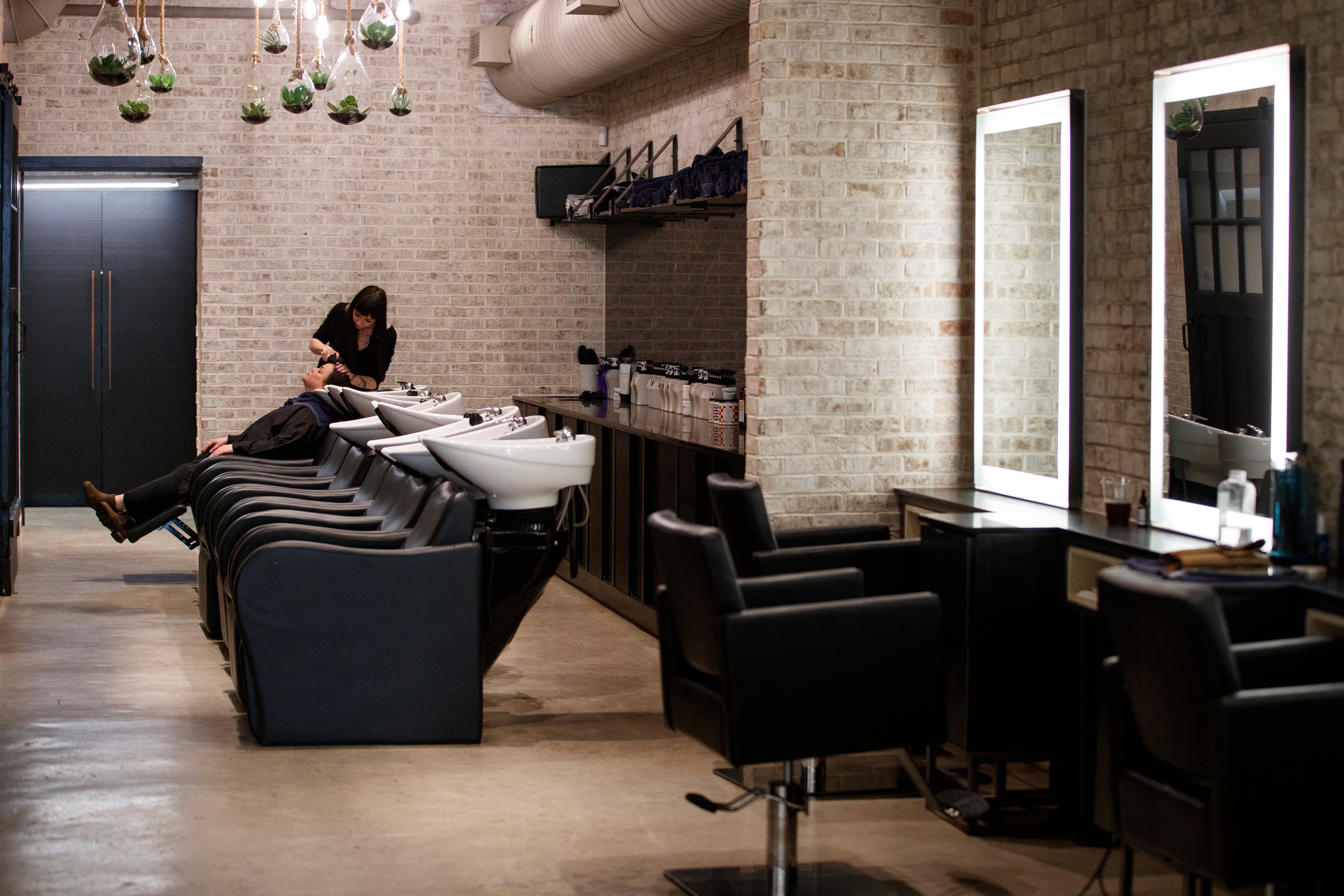 Carol Young has her hair washed and is treated by Ashleah Walker at McCabe Studio at Union Market in Washington