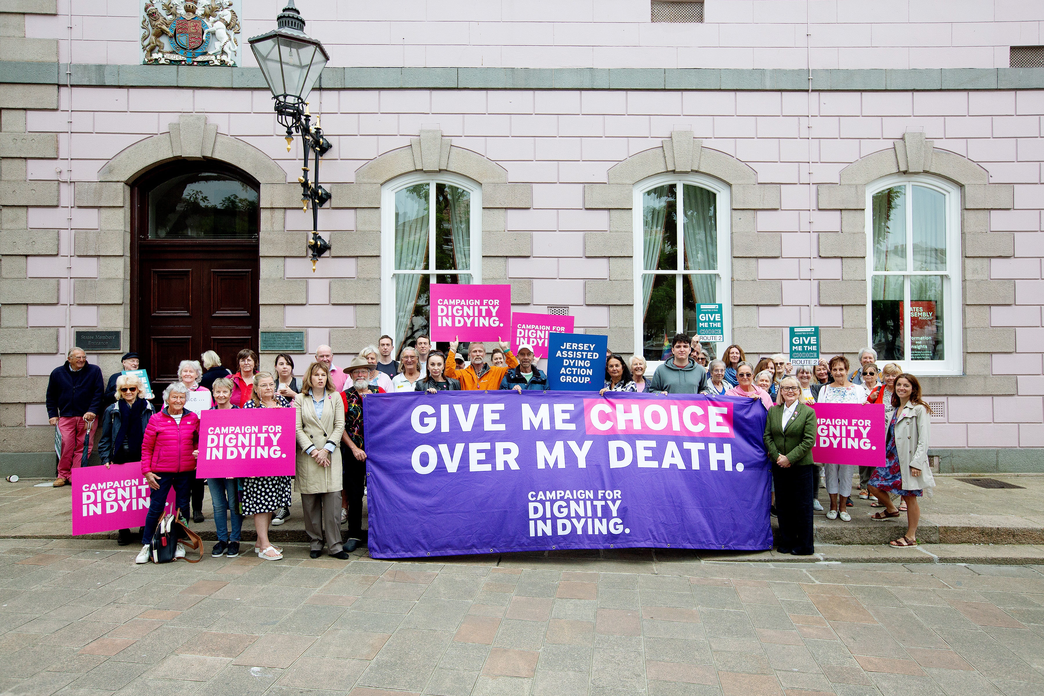 Campaigners outside Jersey State Council, where assisted dying legislation is being debated