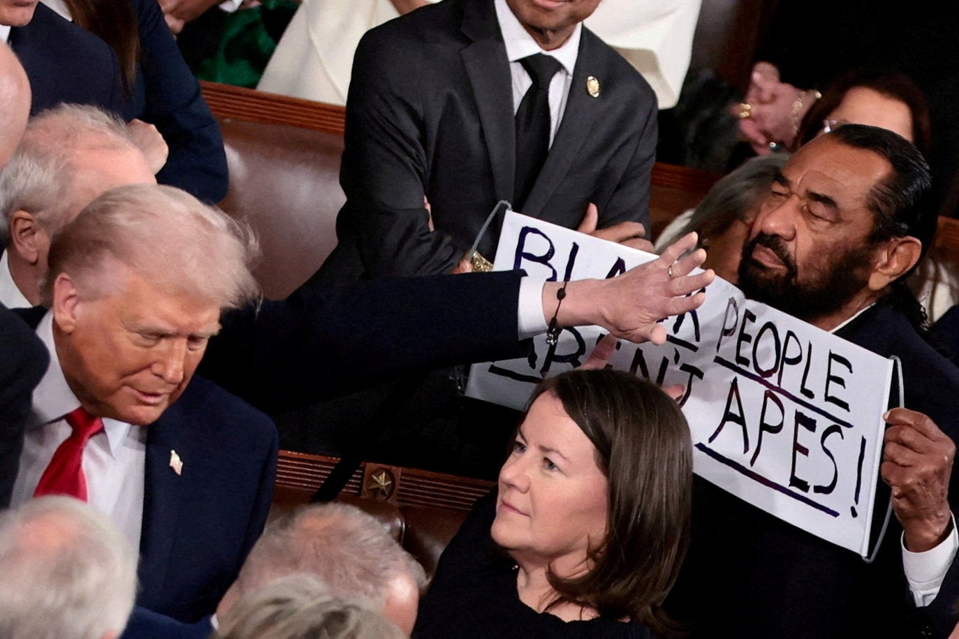 Texas Democrat Al Green holds a sign reading ‘Black people are not apes’ as President Donald Trump arrives to deliver the State of the Union address