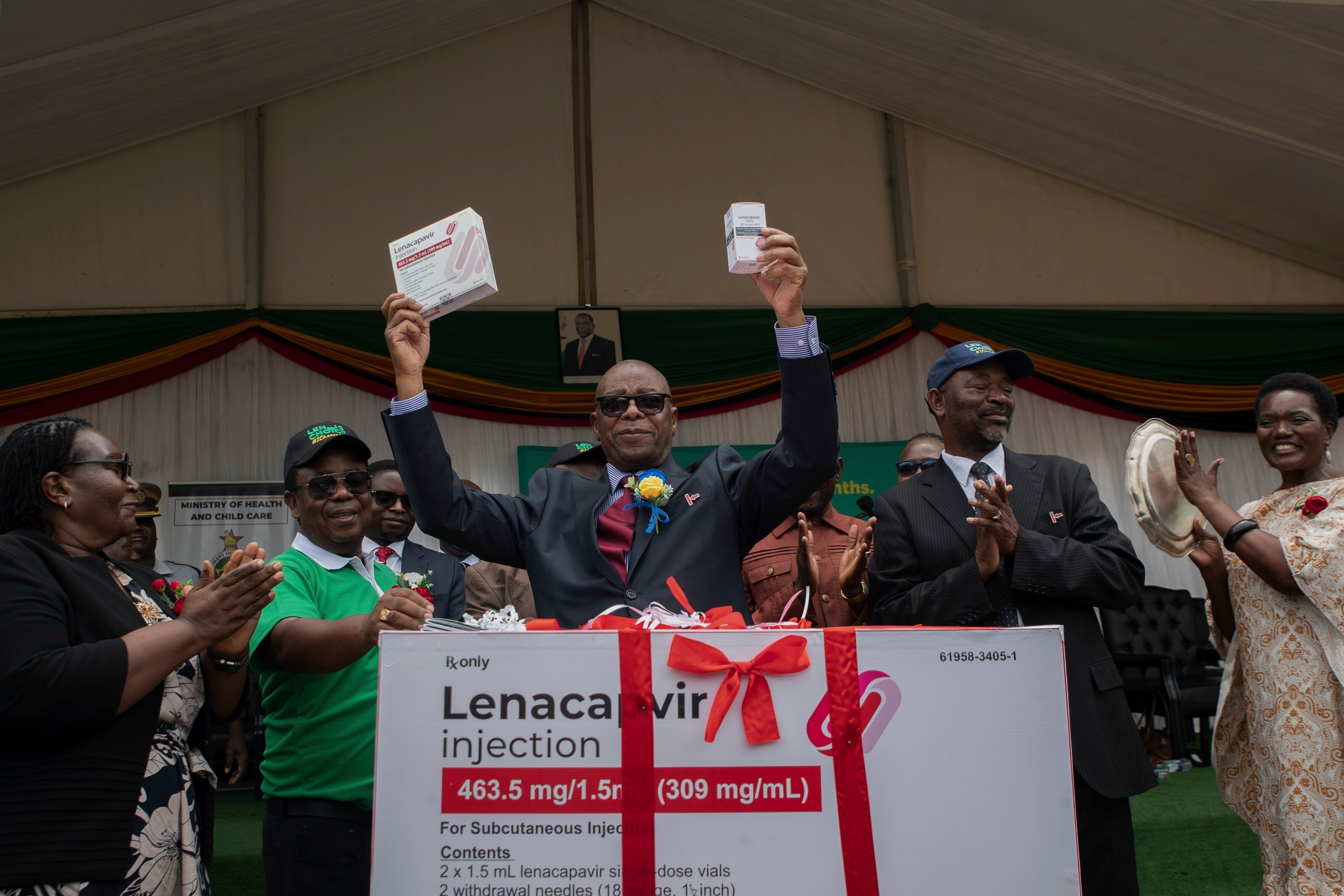Zimbabwe's Minister of Health and Child Care Douglas Mombeshora holds up containers of lenacapavir during its launch in Harare