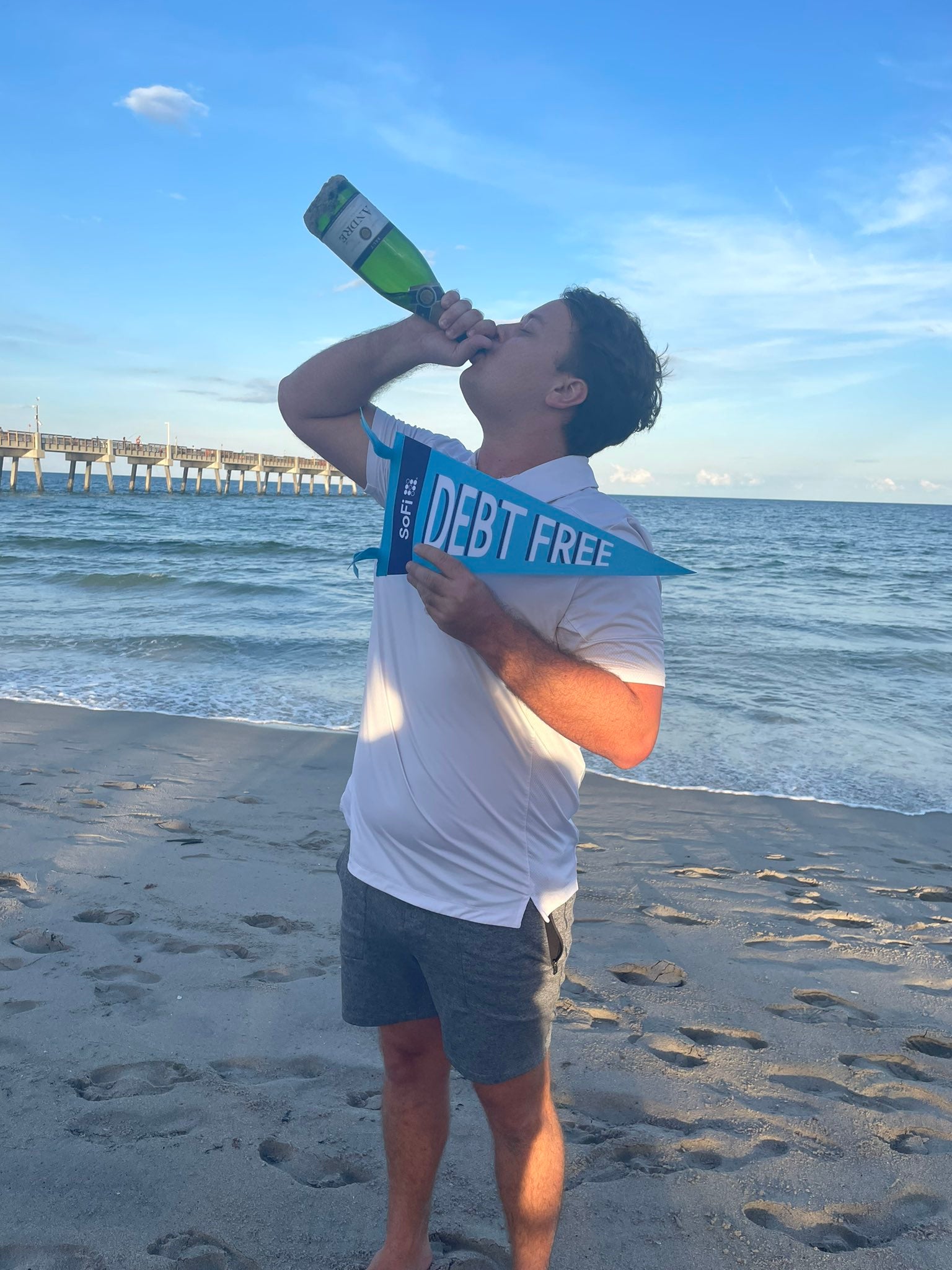 When he made his final debt payment, Brett Holzhauer celebrated with sparkling wine on a Florida beach