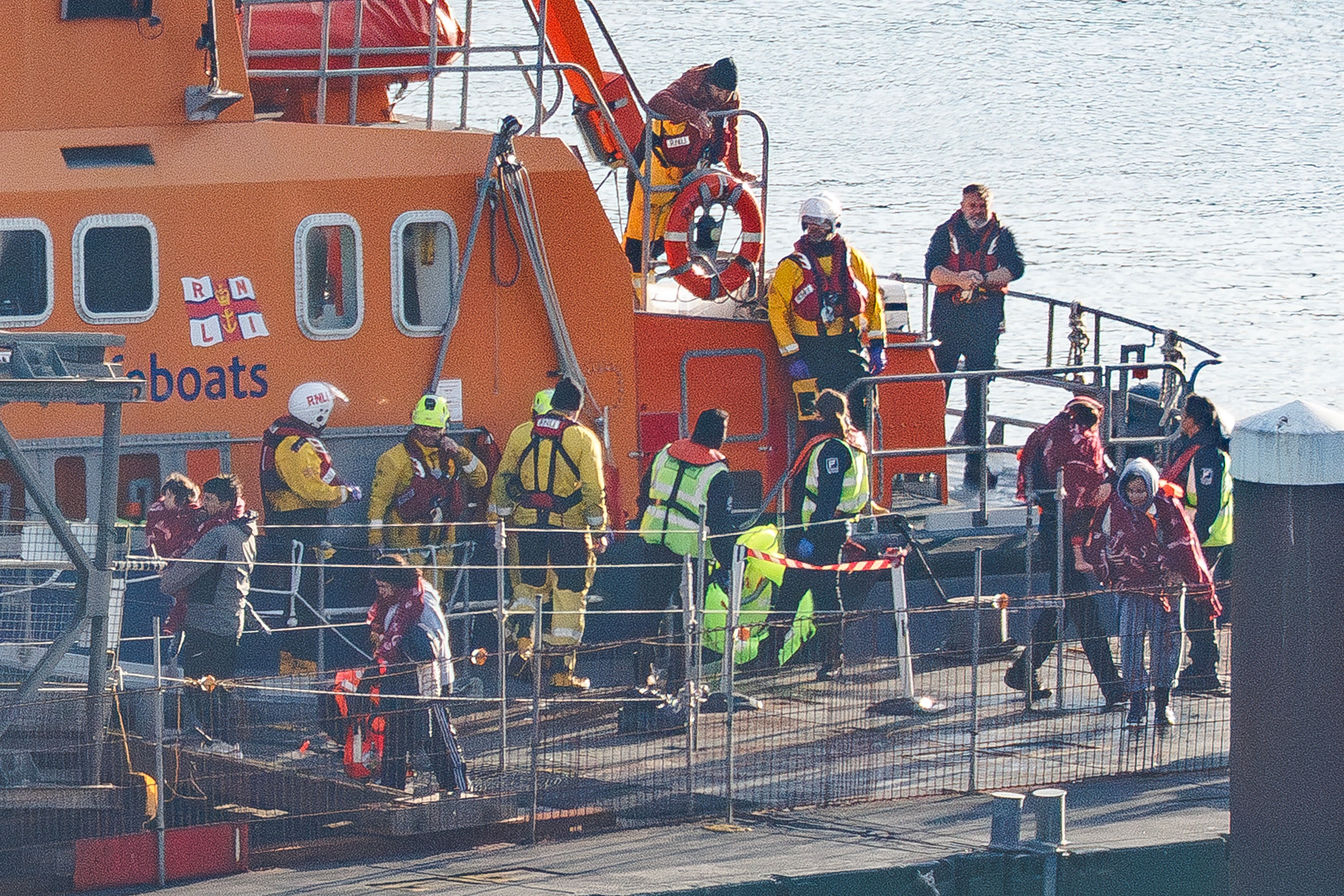 An RNLI lifeboat delivers migrants to Dover port after intercepting a small boat crossing on December 17, 2025 in Dover, England.