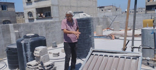 The father of the victims, Ibrahim Al-Aweini, on the roof of his house, reenacts the events of the attack for the Euro-Med Monitor team