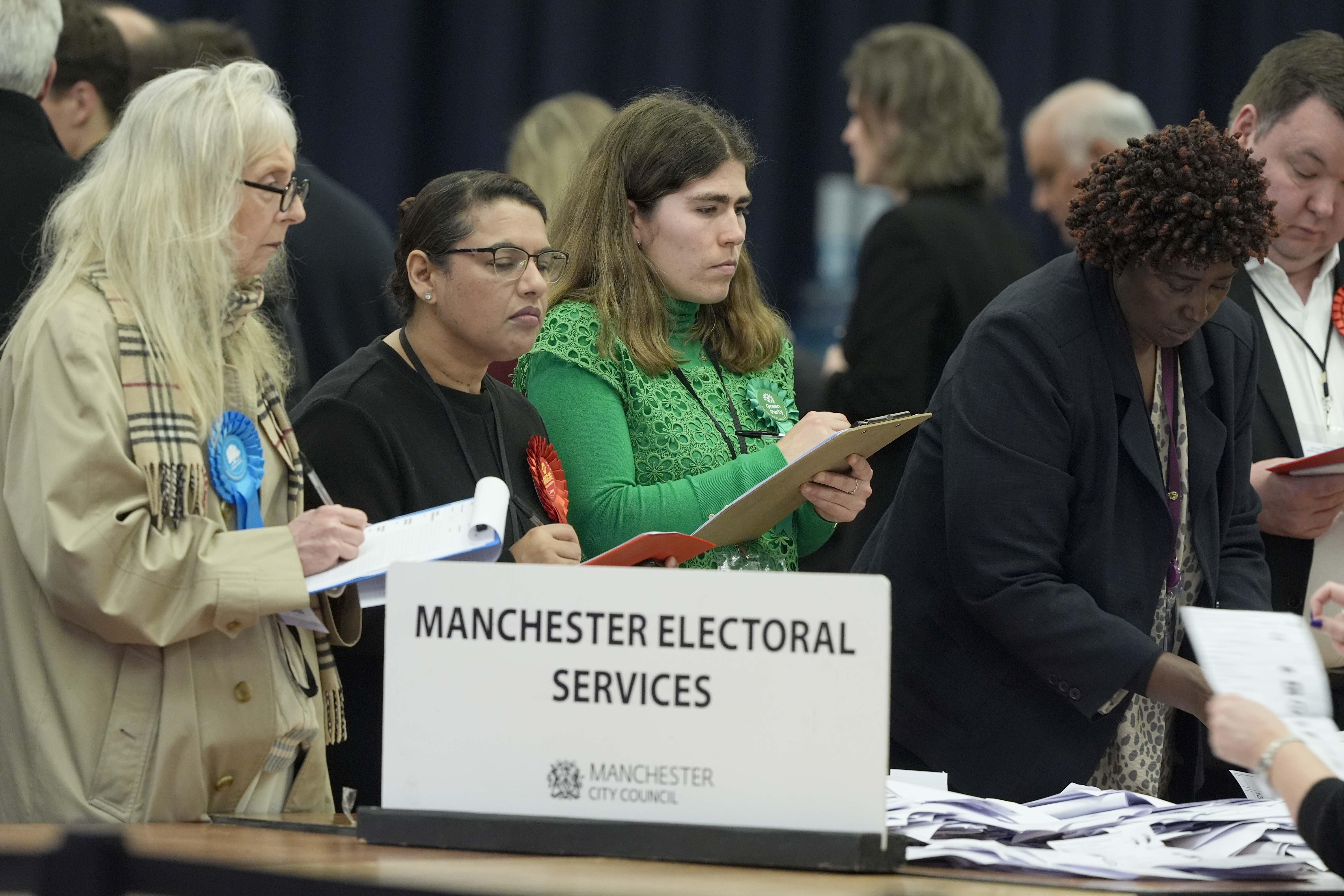 Party observers watch as votes are counted for the Gorton and Denton by-election at Manchester Central (Peter Byrne/PA)