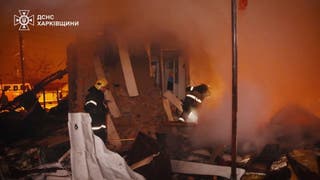 Emergency workers operate at the site of a Russian drone and missile attack in Kharkiv