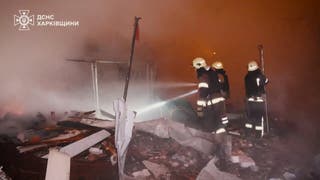 Emergency workers operate at the site of a Russian drone and missile attack in Kharkiv region on Thursday