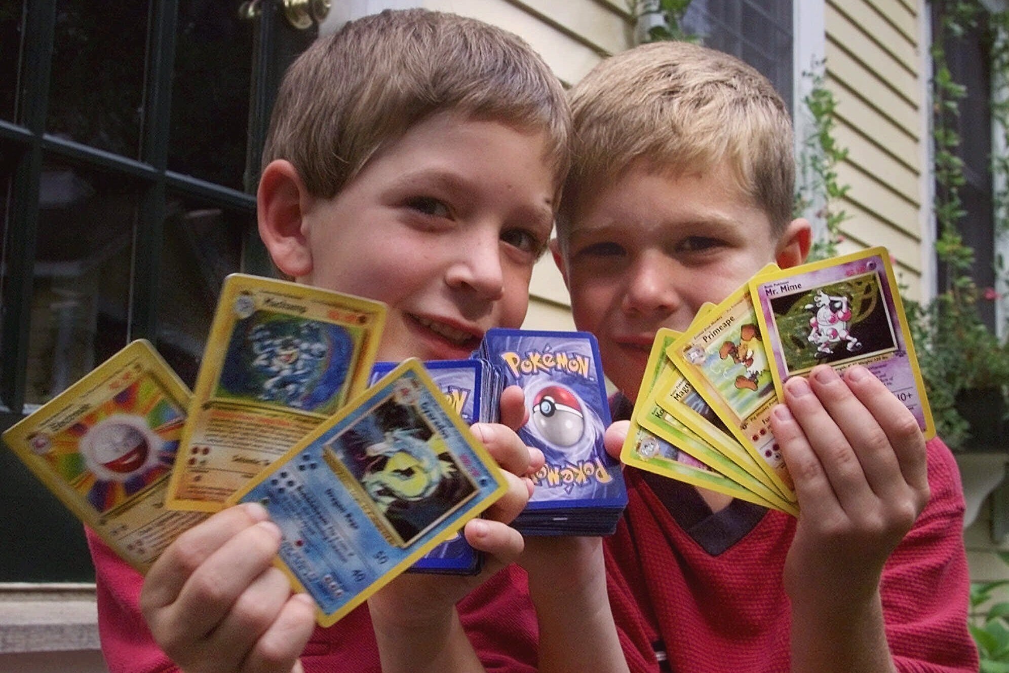 Tyler, right, and his friend George, hold up their favorite Pokemon trading cards, in Scituate, Mass., Sept. 9, 1999