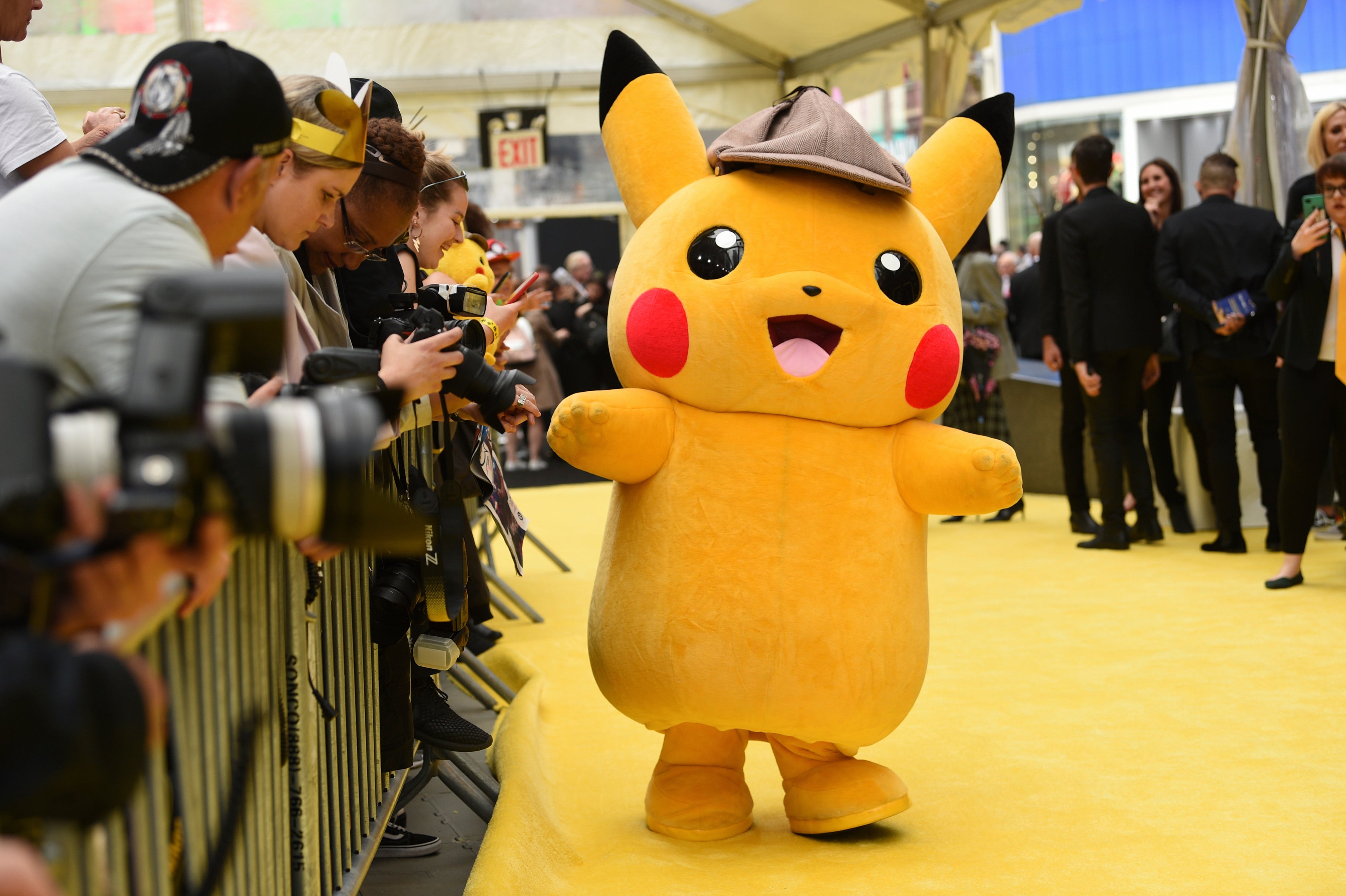 A person in a Pikachu character costume attends the premiere of 