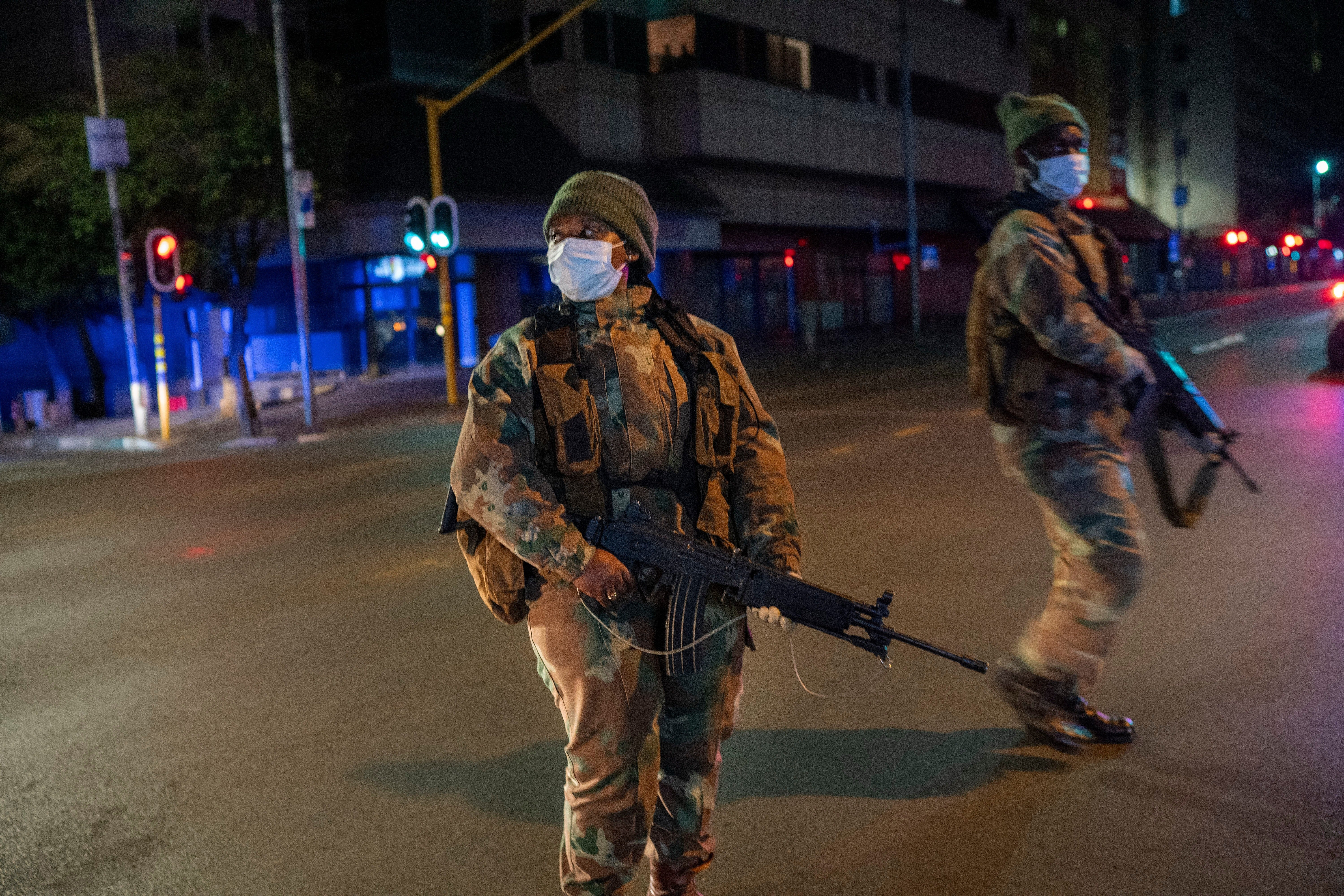 South African Defense Forces patrol downtown Johannesburg, South Africa, March 27, 2020. (AP Photo/Jerome Delay, File)