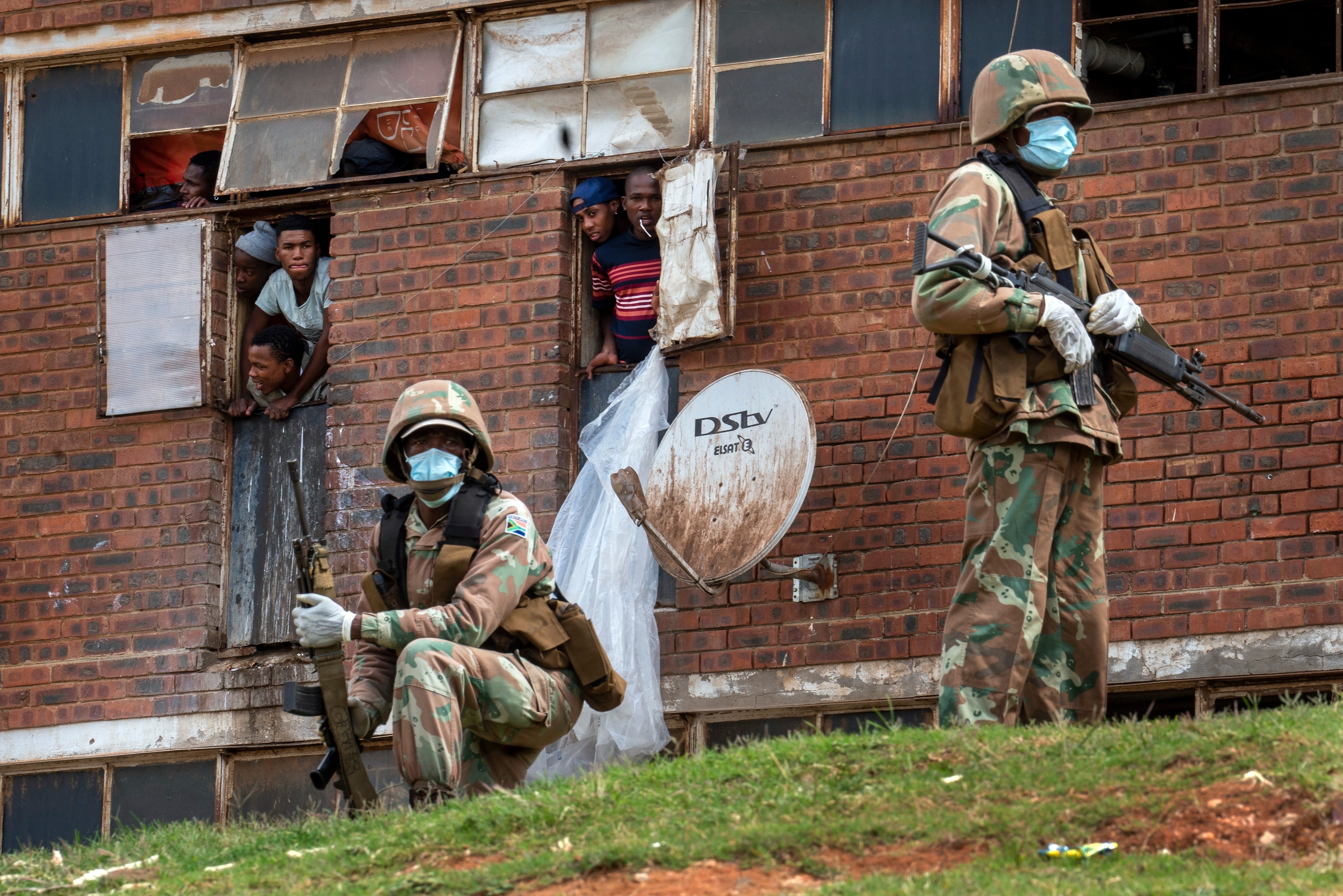 South African National Defense Forces patrol the Men's Hostel in the densely populated Alexandra township east of Johannesburg, Saturday, March 28, 2020. (AP Photo/Jerome Delay, File)
