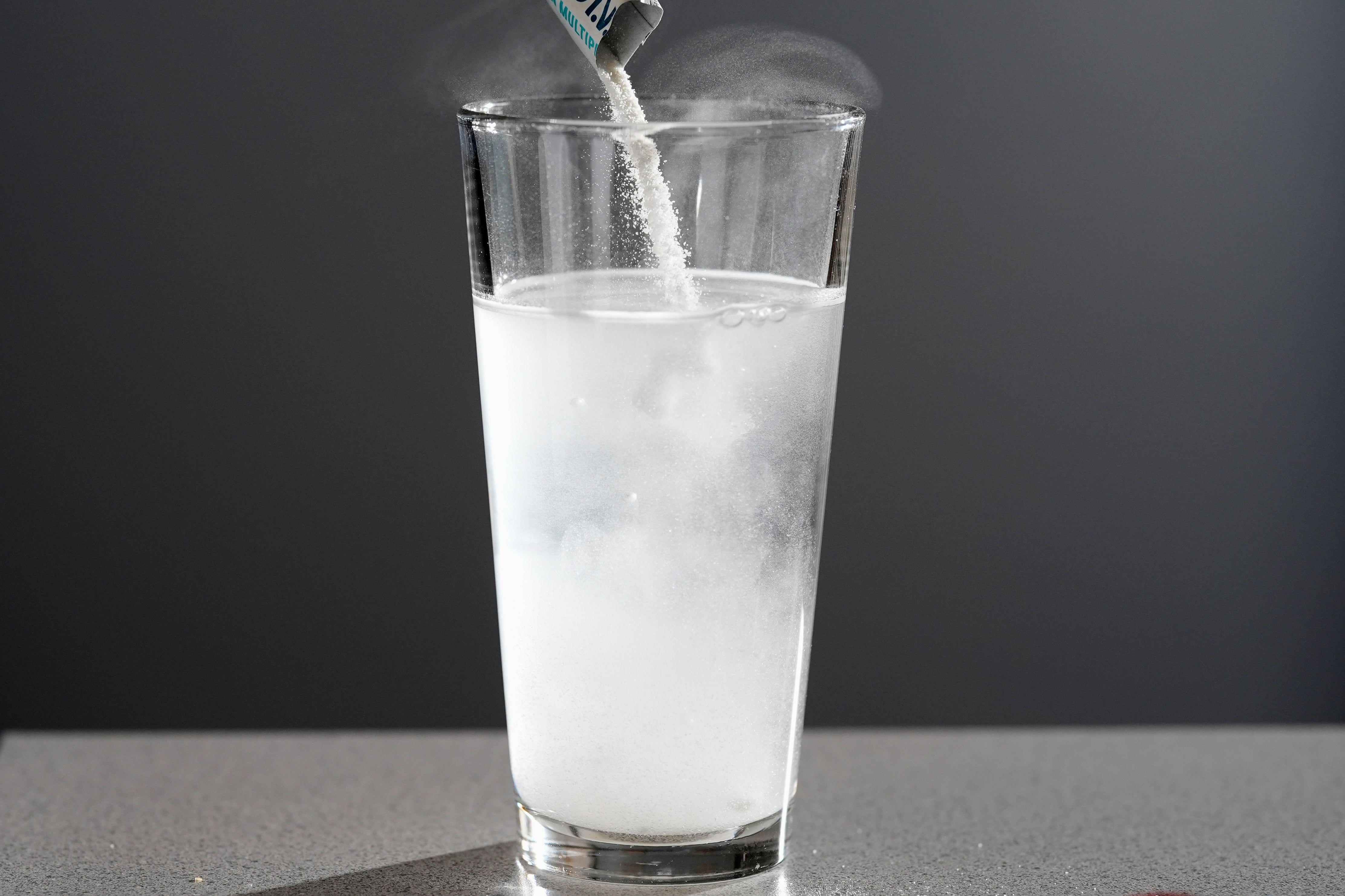 Electrolyte supplements are poured into glass of water Tuesday, Feb. 24, 2026, in Nashville, Tenn. (AP Photo/George Walker IV)