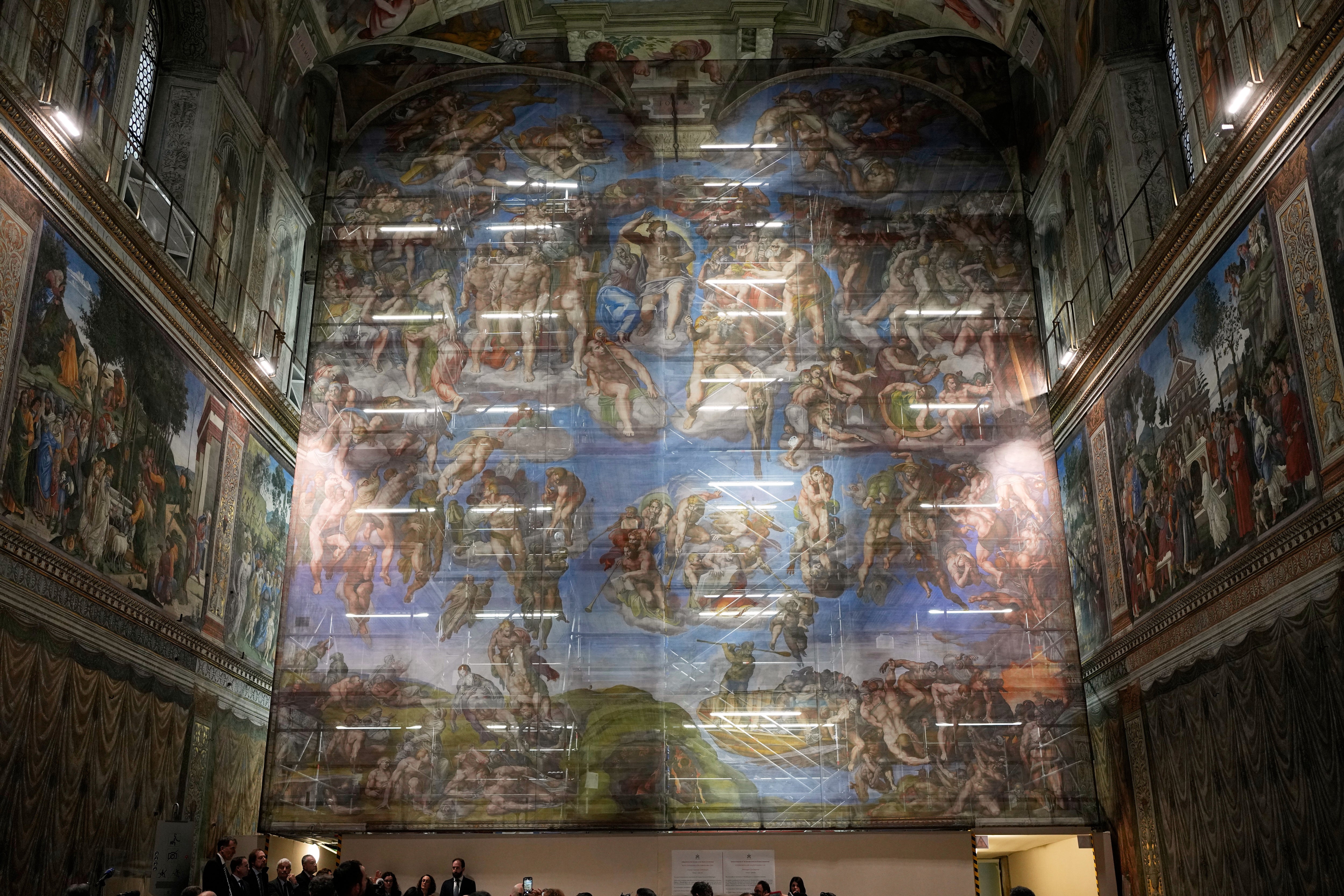 A screen with a replica of ‘The Last Judgment,’ superimposed on it covers the scaffolding used for its extraordinary maintenance during a presentation for press in the Sistine Chapel at the Vatican, Saturday, Feb. 28, 2026. (AP Photo/Alessandra Tarantino)