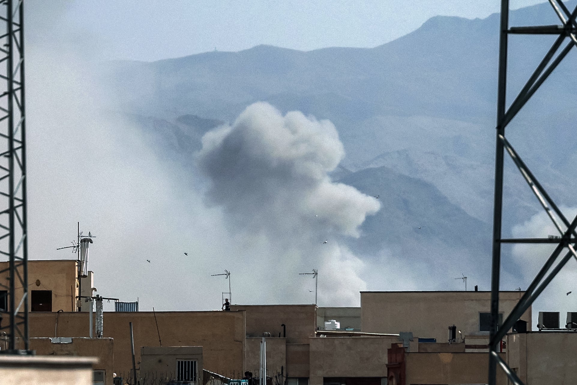 A plume of smoke rises following a reported explosion in Tehran on February 28, 2026