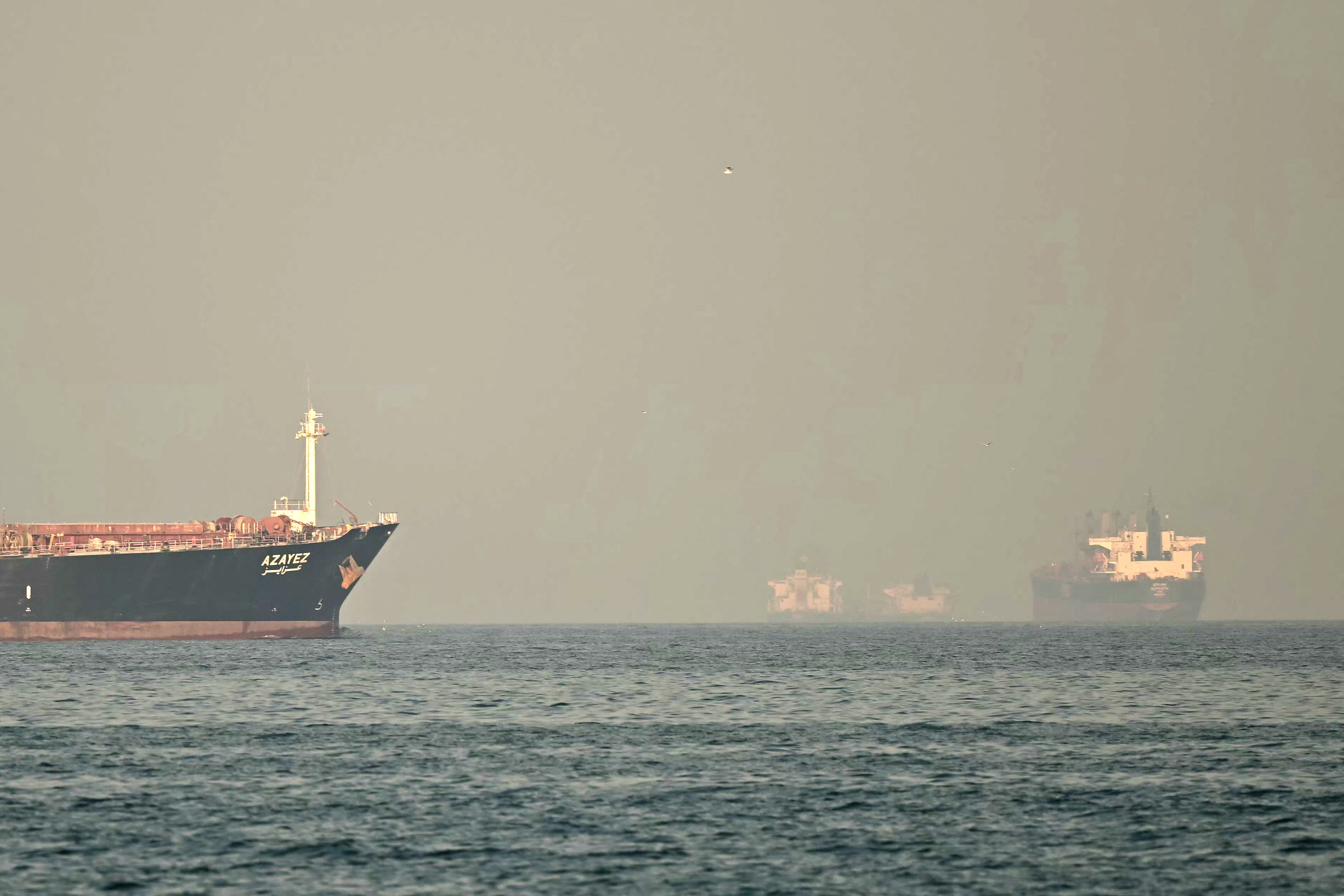 Cargo ships and tankers are seen off coast city of Fujairah, in the Strait of Hormuz in the northern Emirate on February 25, 2026. (Photo by Giuseppe CACACE / AFP via Getty Images)