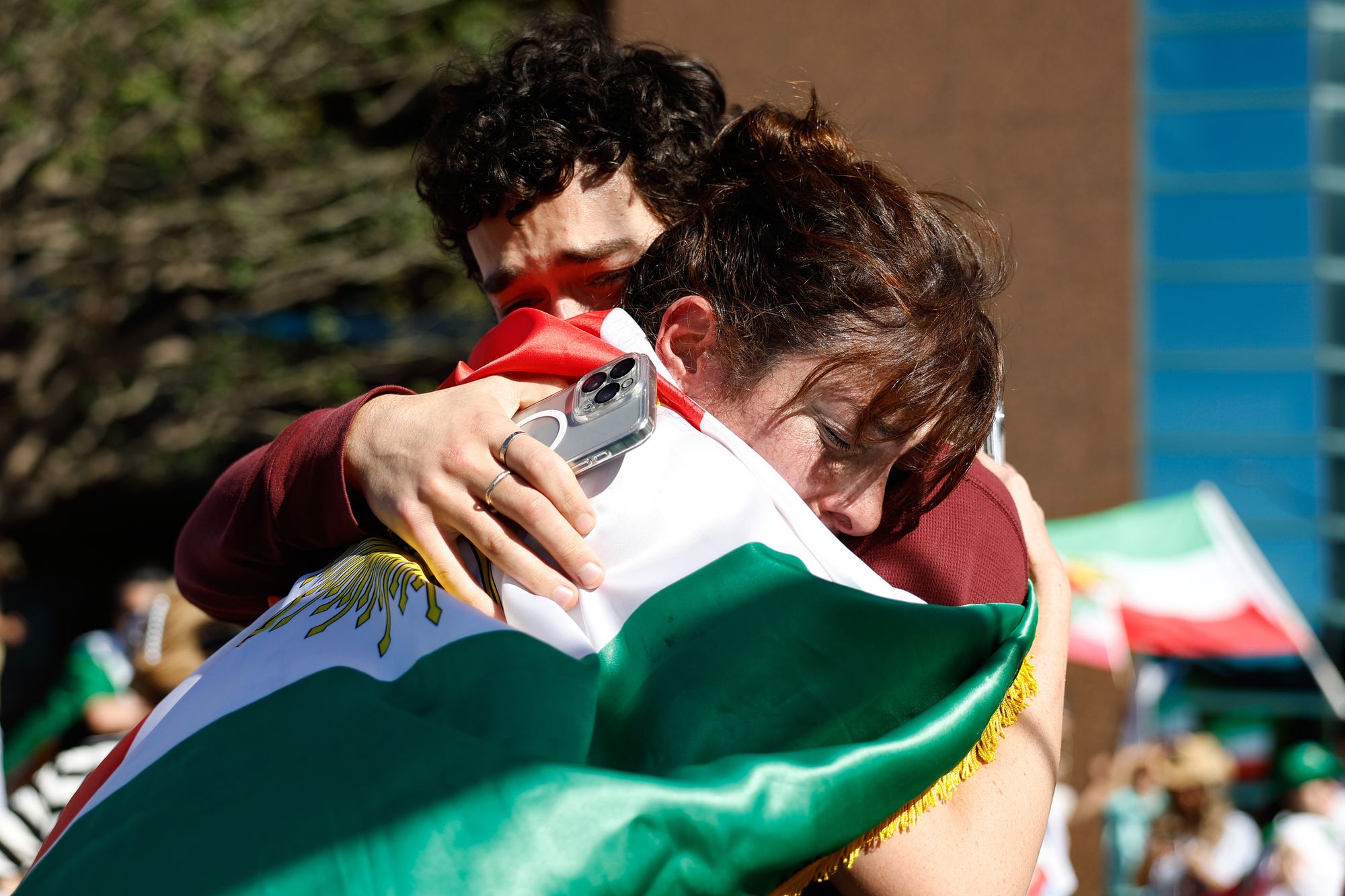 Two people embrace during a demonstration in reaction to the U.S. and Israeli strikes on Iran on Saturday, Feb. 28, 2026, in Los Angeles