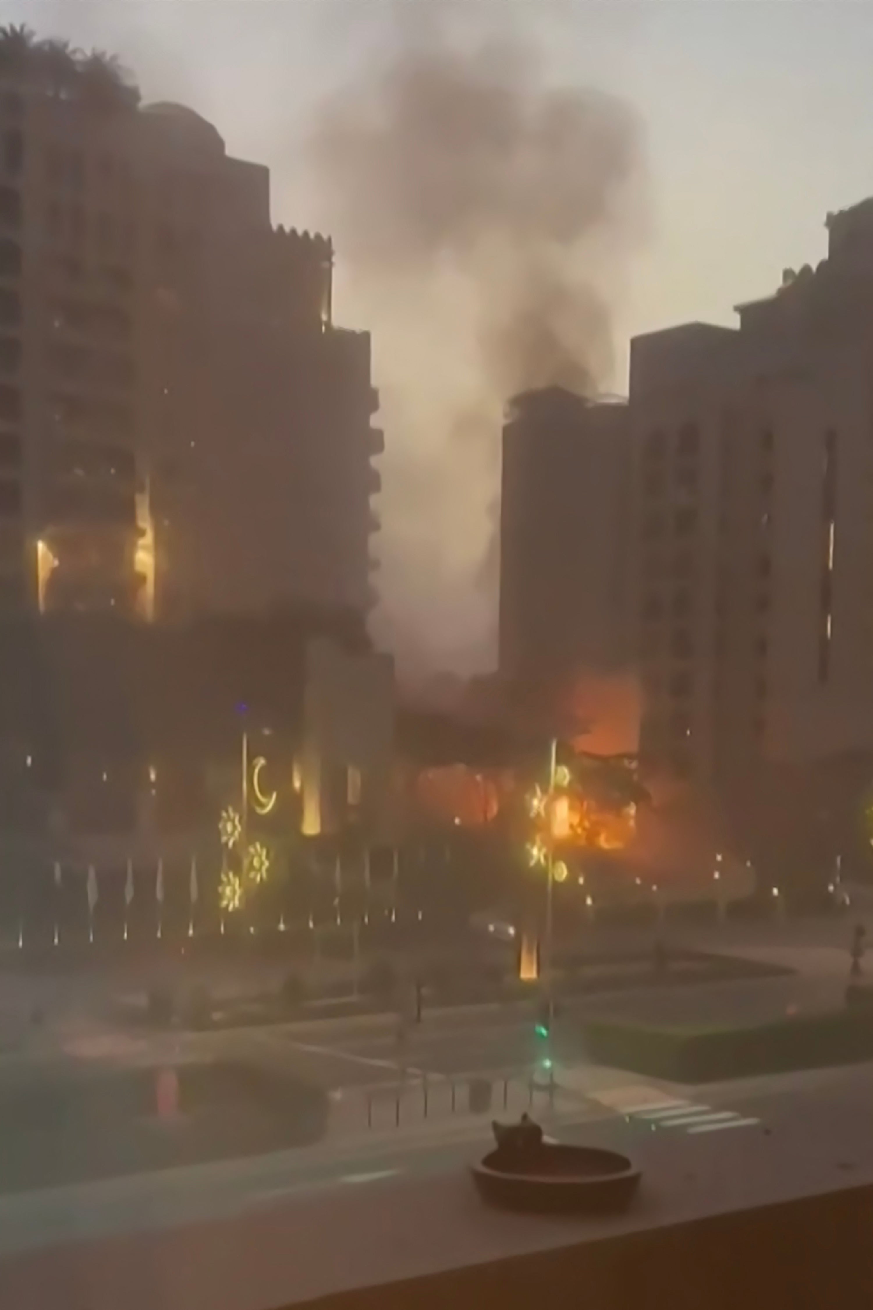 This video grab taken from UGC images posted on social media on February 28, 2026, shows smoke and flames rising from Dubai's landmark The Palm archipelago, as Iran carried out retaliatory strikes in the Gulf following US and Israeli attacks.