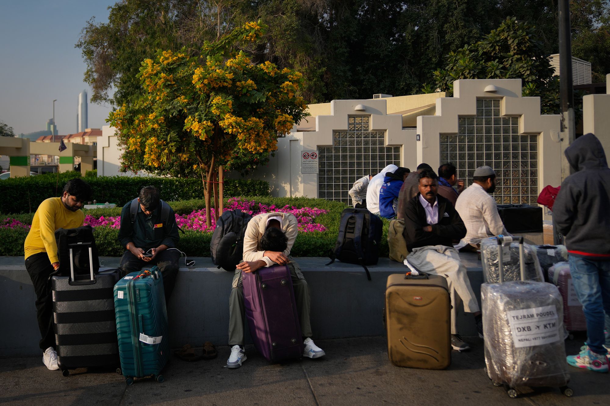Passengers stranded by the closure of Dubai International Airport await for assistance in the airport parking lot in Dubai, United Arab Emirates, Sunday, March 1, 2026.