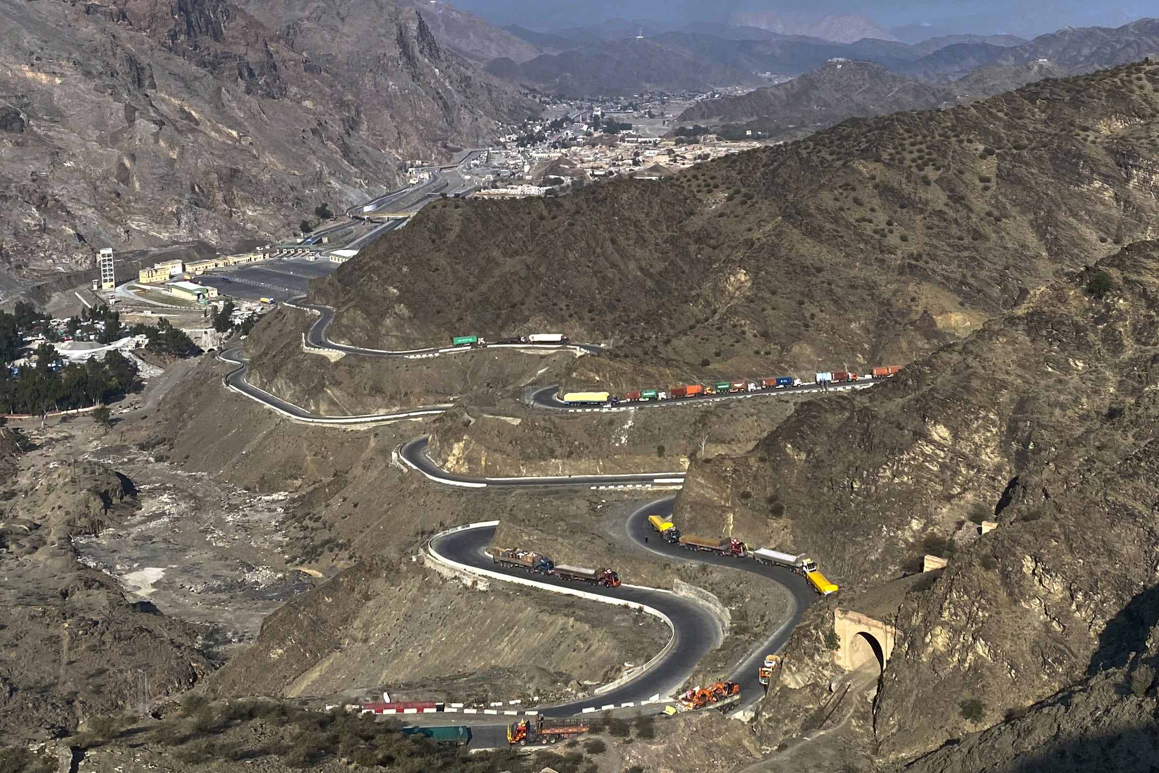Trucks are parked along roadside following cross-border clashes between Pakistan and Afghan forces, at near Torkham border crossing point, Pakistan, Saturday, Feb. 28, 2026. (AP Photo/Maaz Awan)
