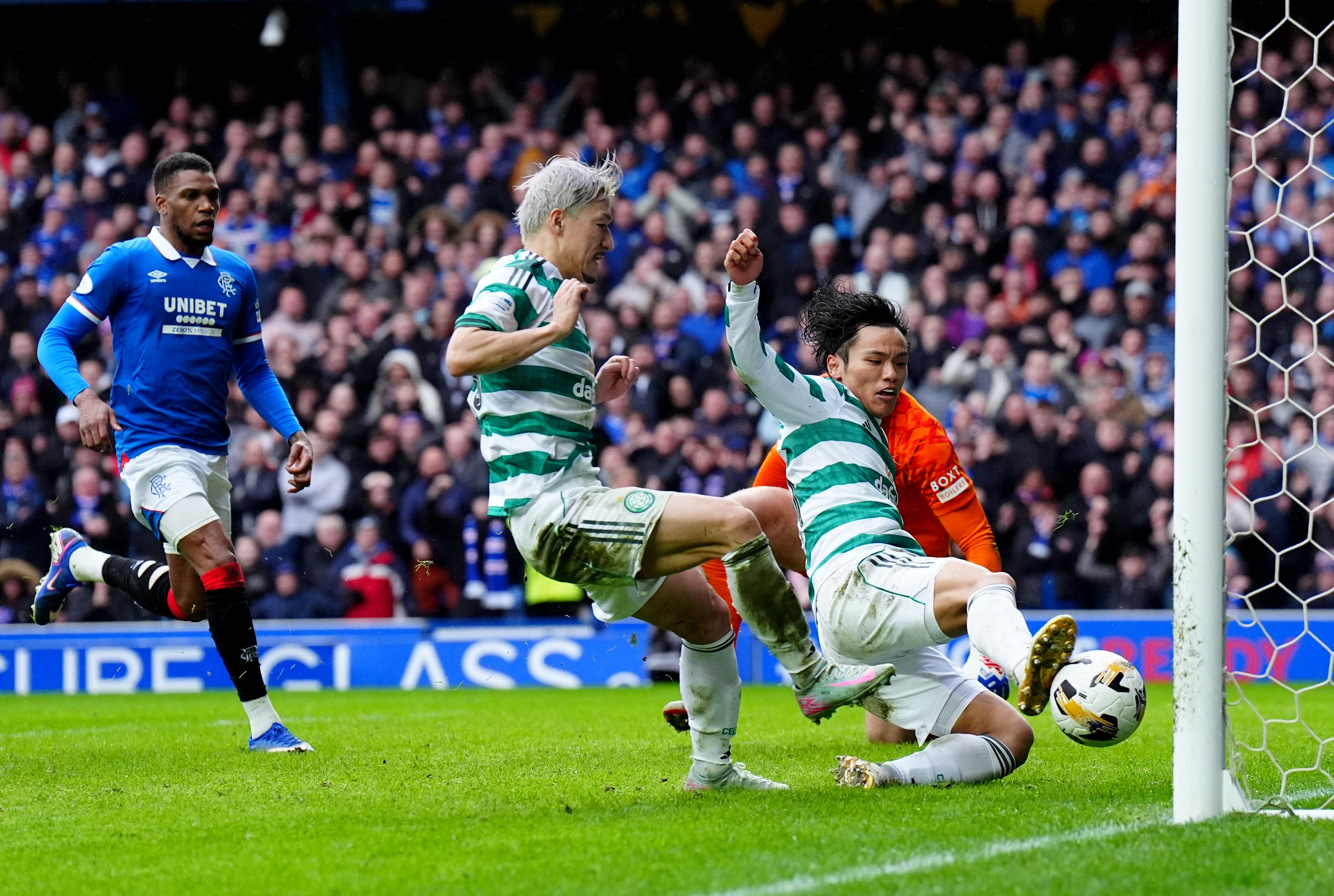 Celtic’s Reo Hatate follows up his saved penalty to equalise in the 91st minute and deny Rangers all three points