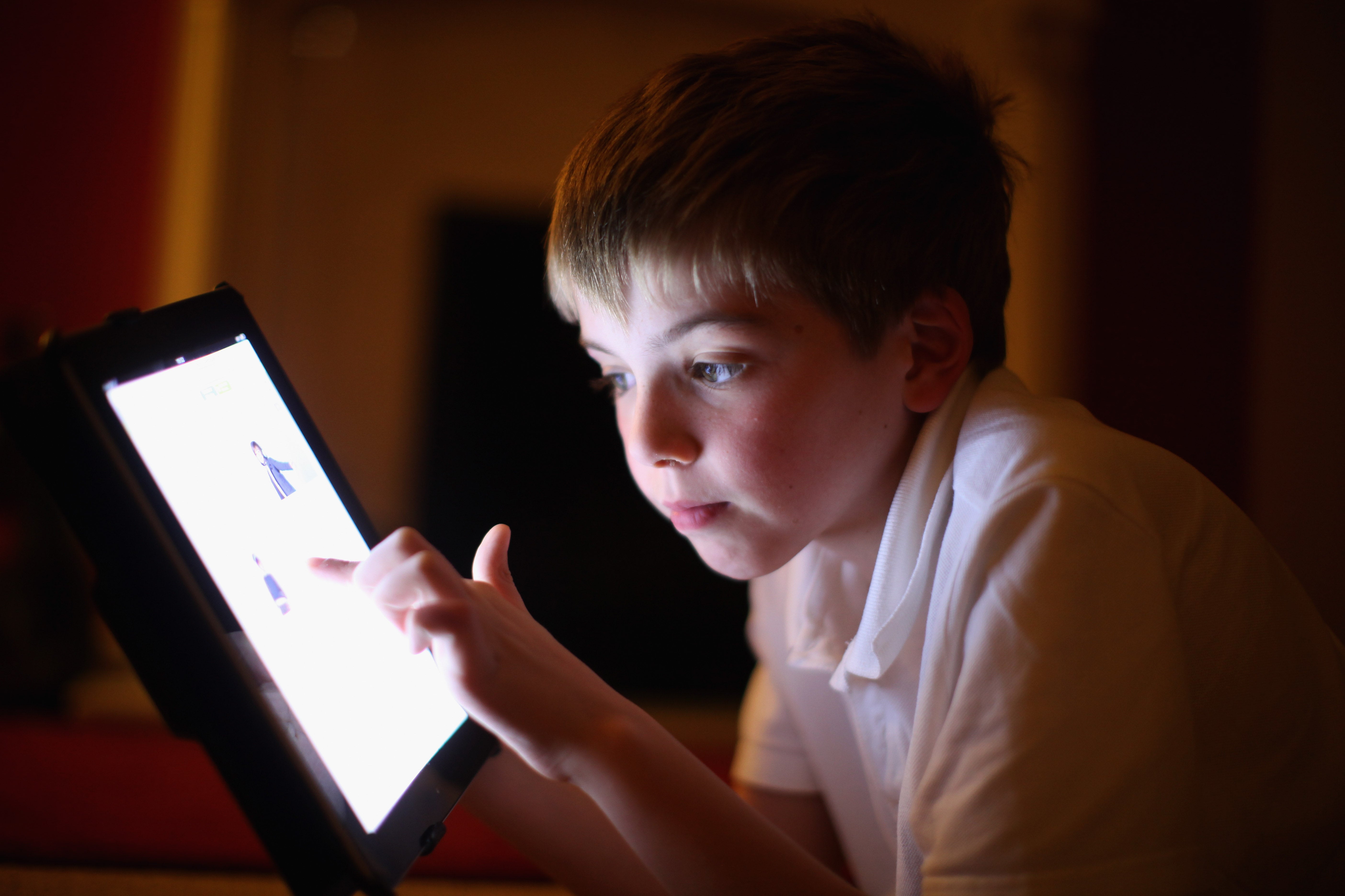 A ten-year-old boy uses an Apple Ipad tablet computer. Ministers are looking at ways to limit children’s social media use