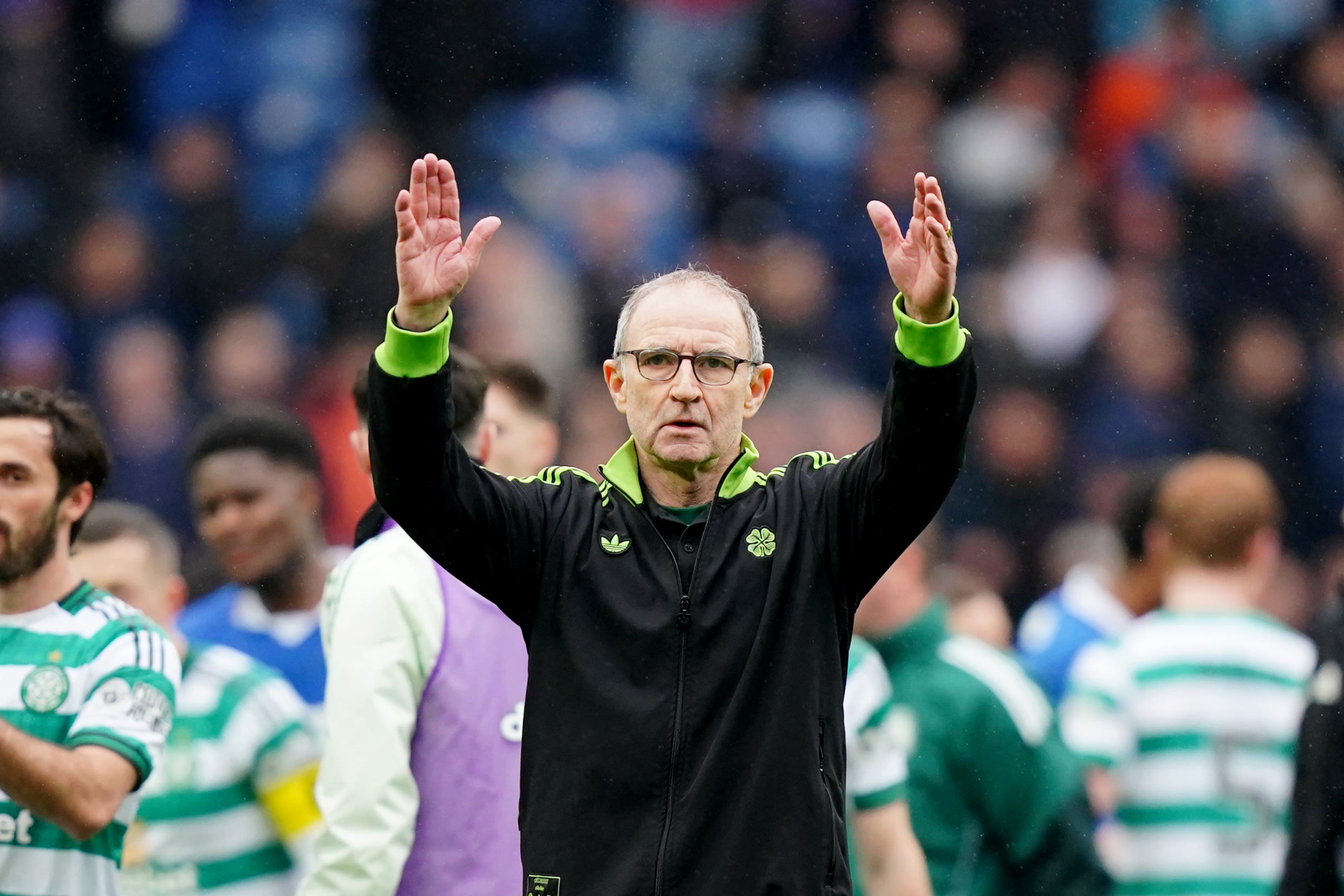 Martin O’Neill (centre) salutes Celtic fans after a comeback at Ibrox (Jane Barlow/PA)