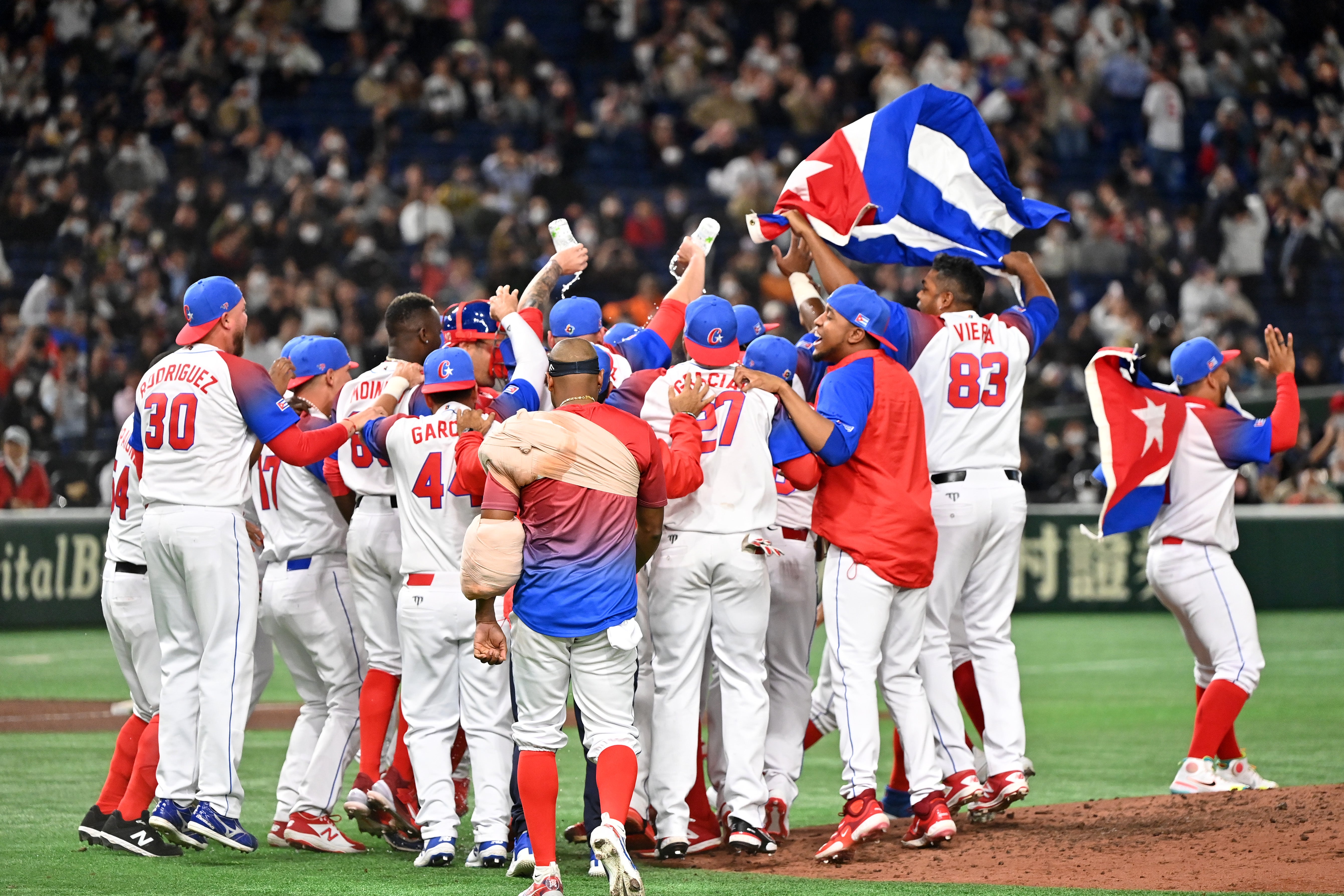 Cuba players celebrate the team's victory and the qualification for semifinals following the World Baseball Classic quarterfinal between Australia and Cuba at Tokyo Dome on March 15, 2023 in Tokyo, Japan