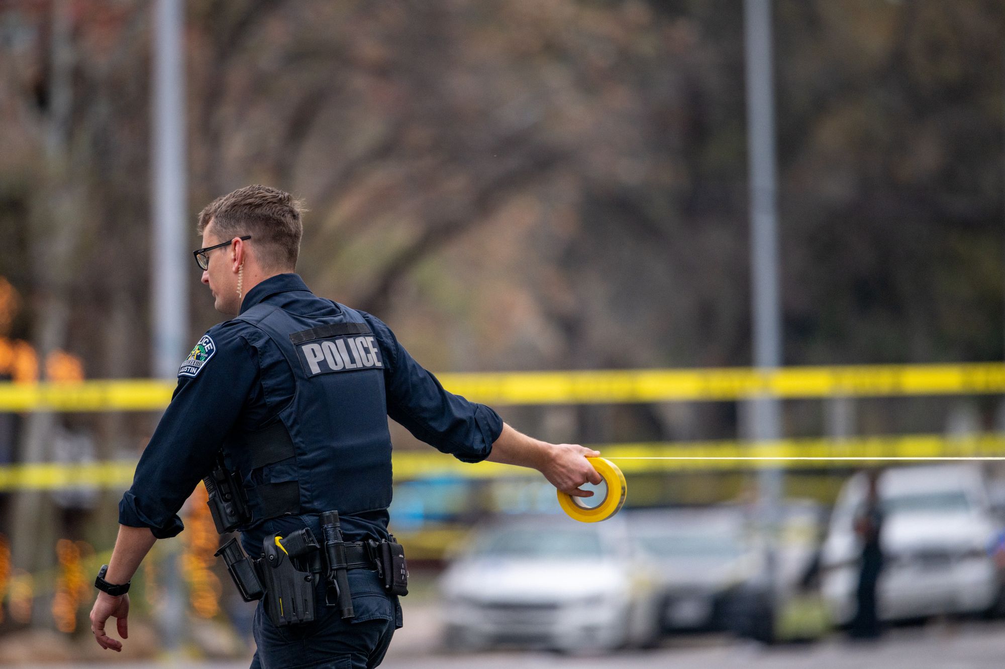 An Austin police officer blocks off an intersection with caution tape near Buford's bar