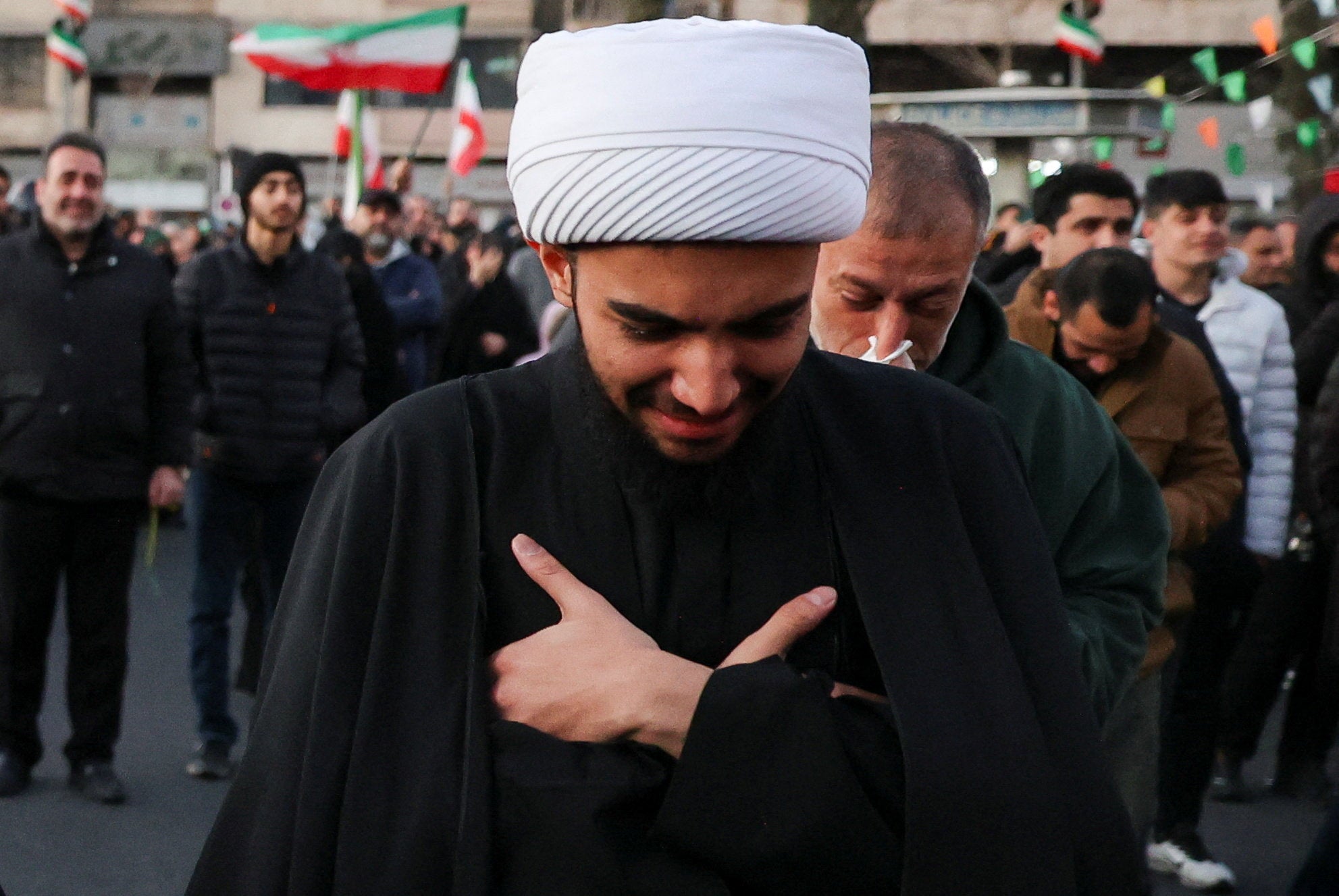A man reacts as people gather at the Enghelab Square, after Iran's Supreme Leader Ayatollah Ali Khamenei was killed in Israeli and U.S. strikes on Saturday, in Tehran