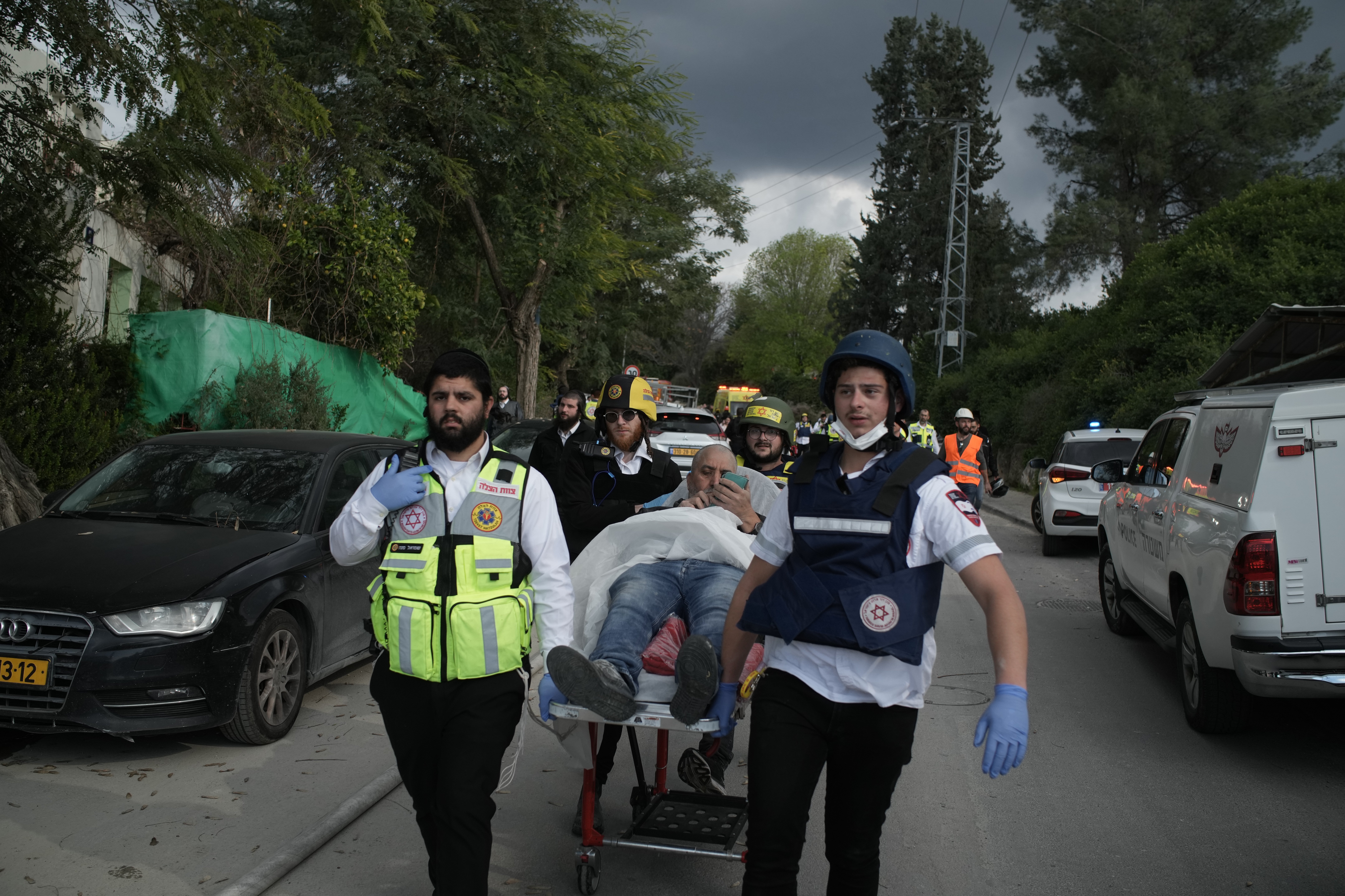 Paramedics evacuate wounded people from the site of a deadly Iranian missile strike in Beit Shemesh, Israel