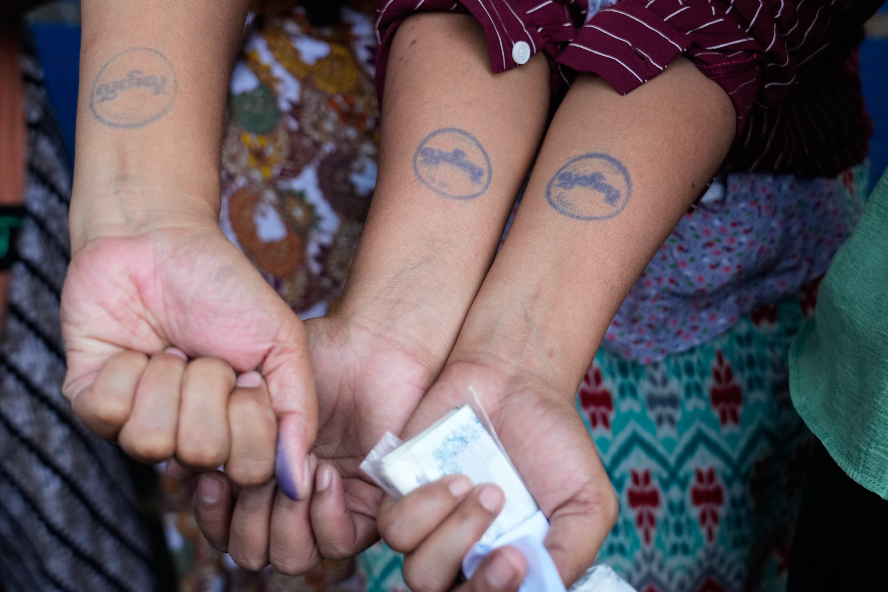 Released prisoners show their arms stamped as 