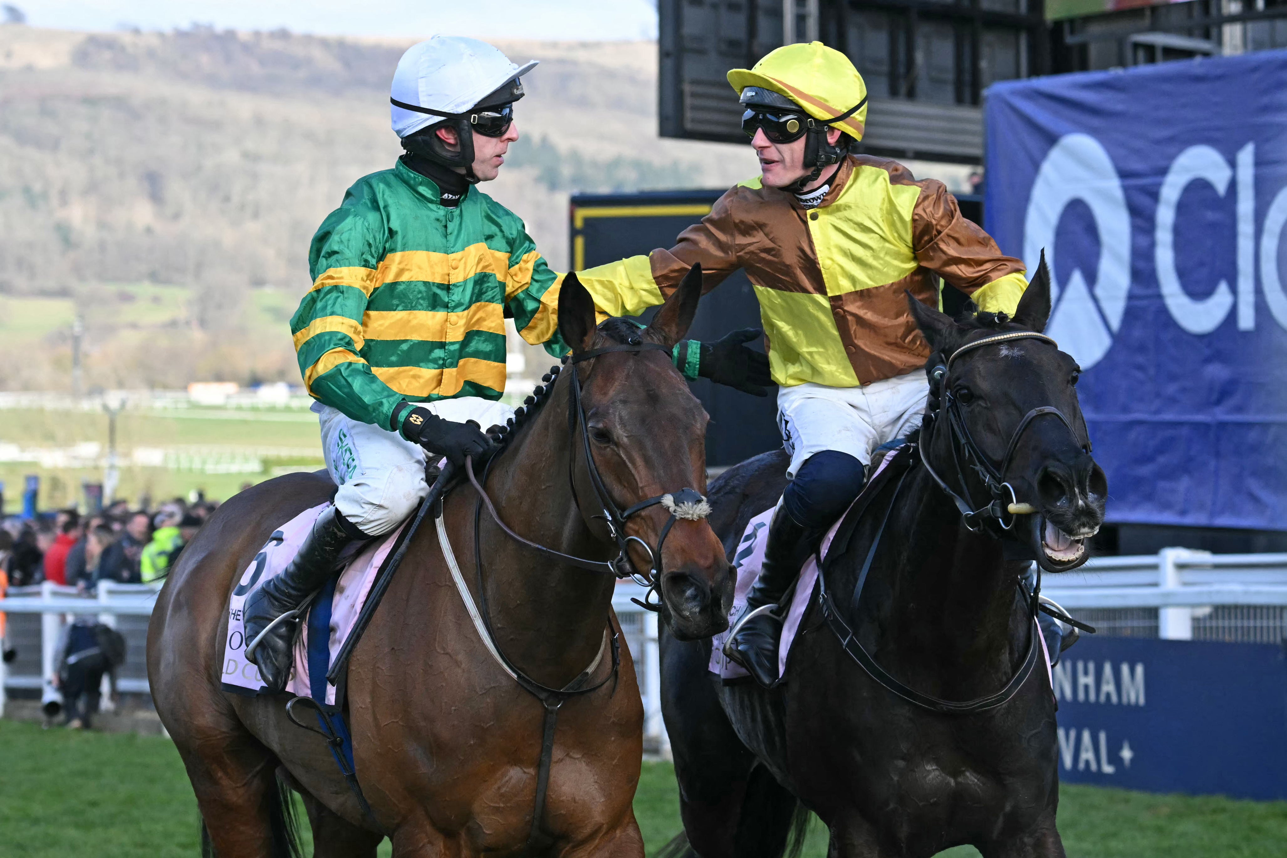 Jockey Mark Walsh (left) on Inothewayurthinkin is congratulated by jockey Paul Townend on (right) Galopin Des Champs after the 2025 Gold Cup