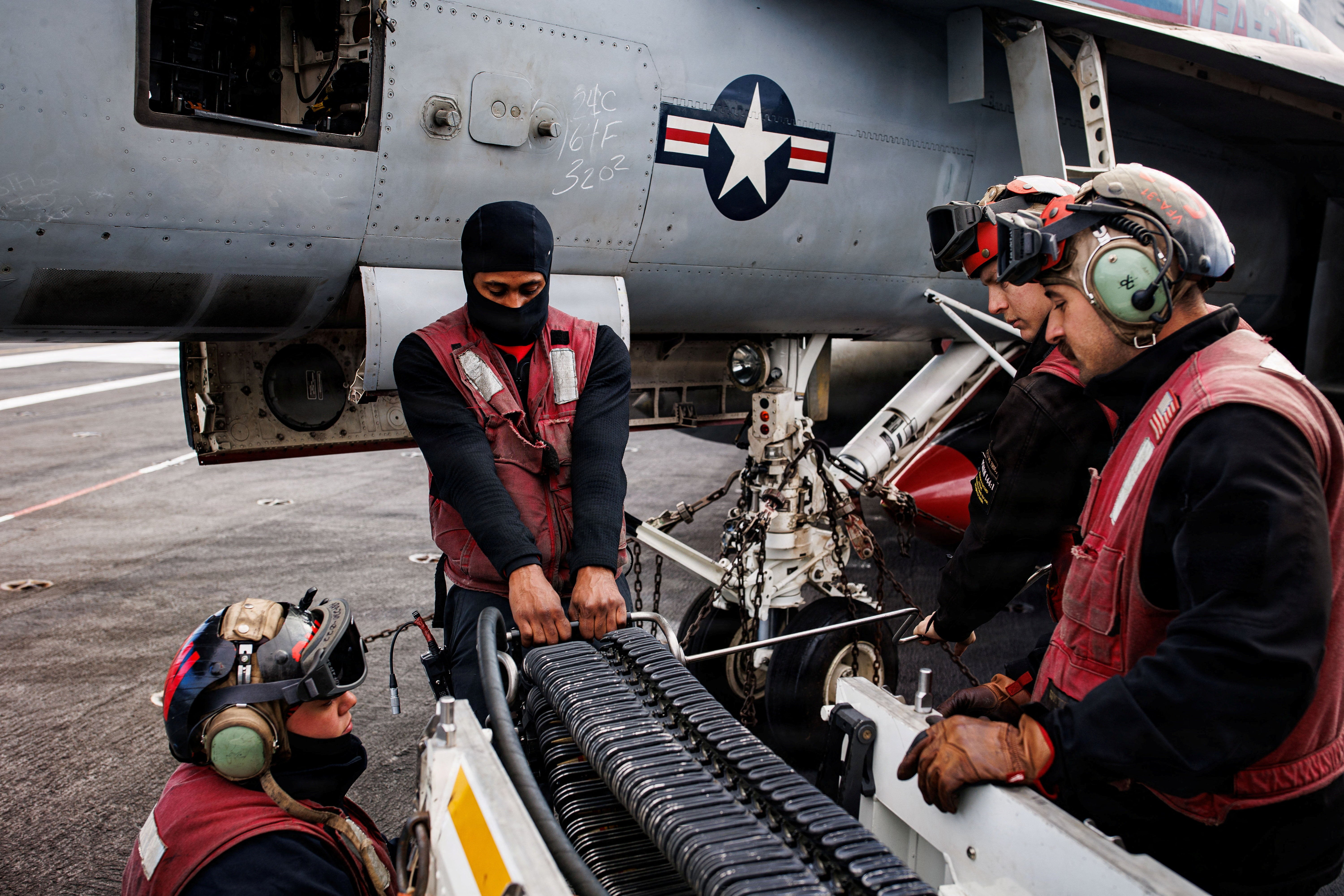 Navy sailors loaded up aircraft on the USS Gerald R. Ford aircraft carrier as it commenced attacks on Iran