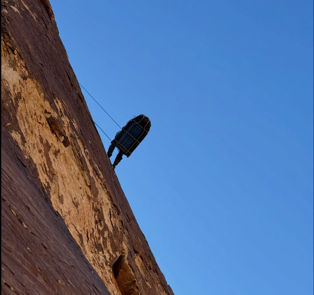 A titanium litter holding an injured climber is lowered from the 'Dream Safari' climbing route in Pine Creek Canyon near Las Vegas. A climber fell more than 40 feet and sustained severe injuries to his head and back, requiring a rescue from a position on the wall approximately 600 feet above ground